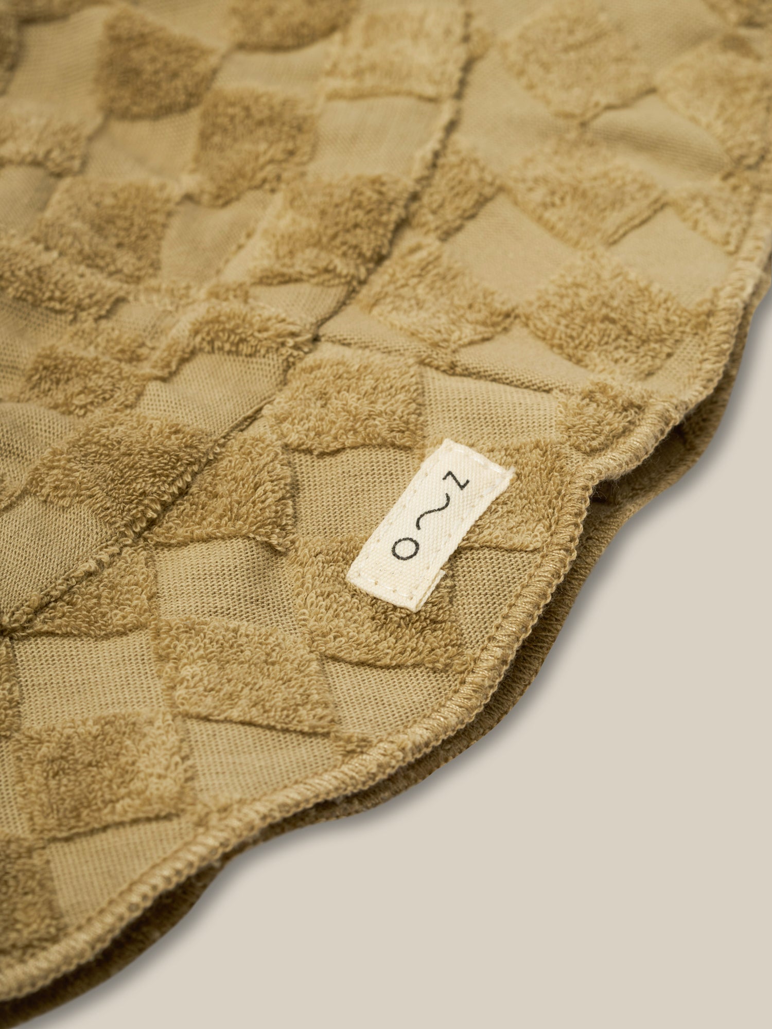 close up of baby & toddler dusky beige checkerboard sun hat in soft organic terry cotton with o~z label