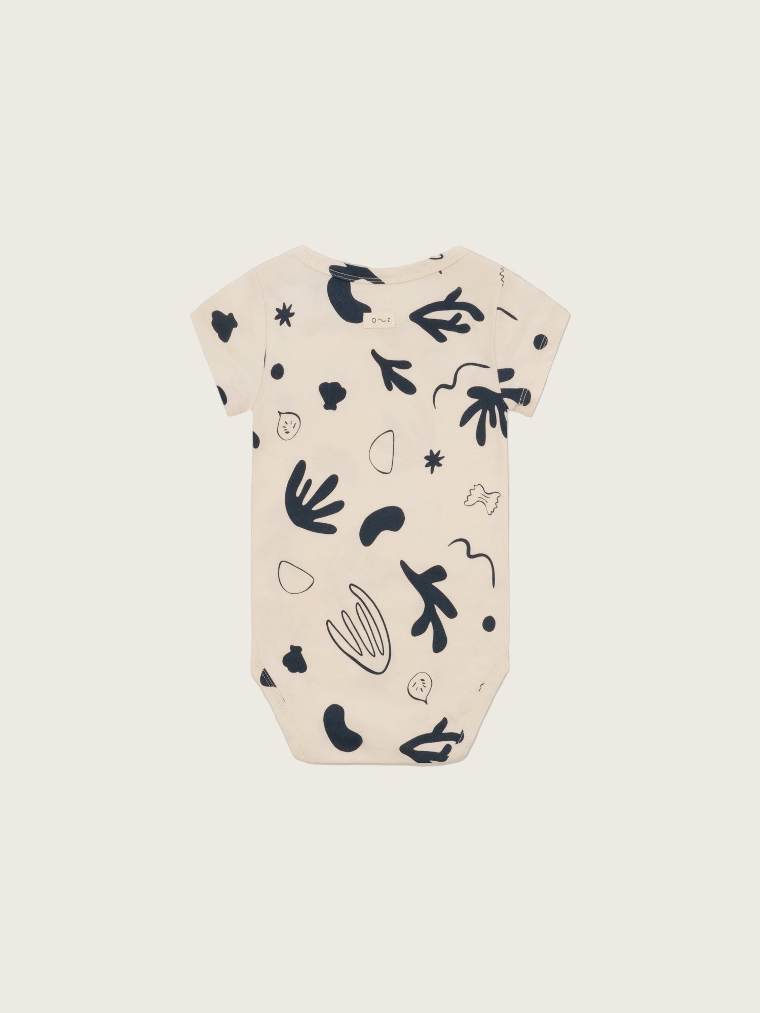 baby undyed cotton short sleeved capri bodysuit in white with ocean print, shoulder & crotch poppers