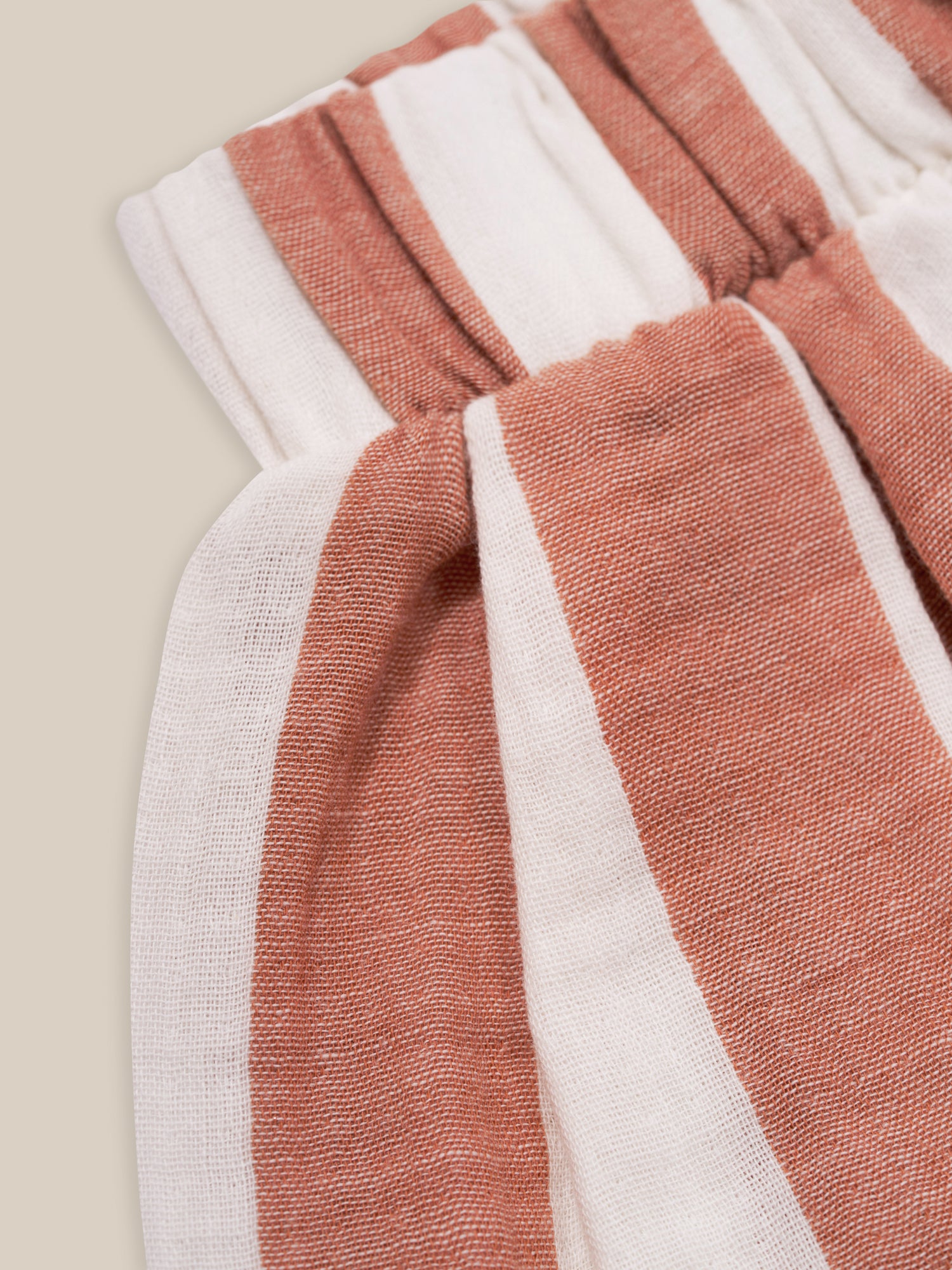 close up of baby & toddler organic muslin red striped balloon trousers with elastic waistband