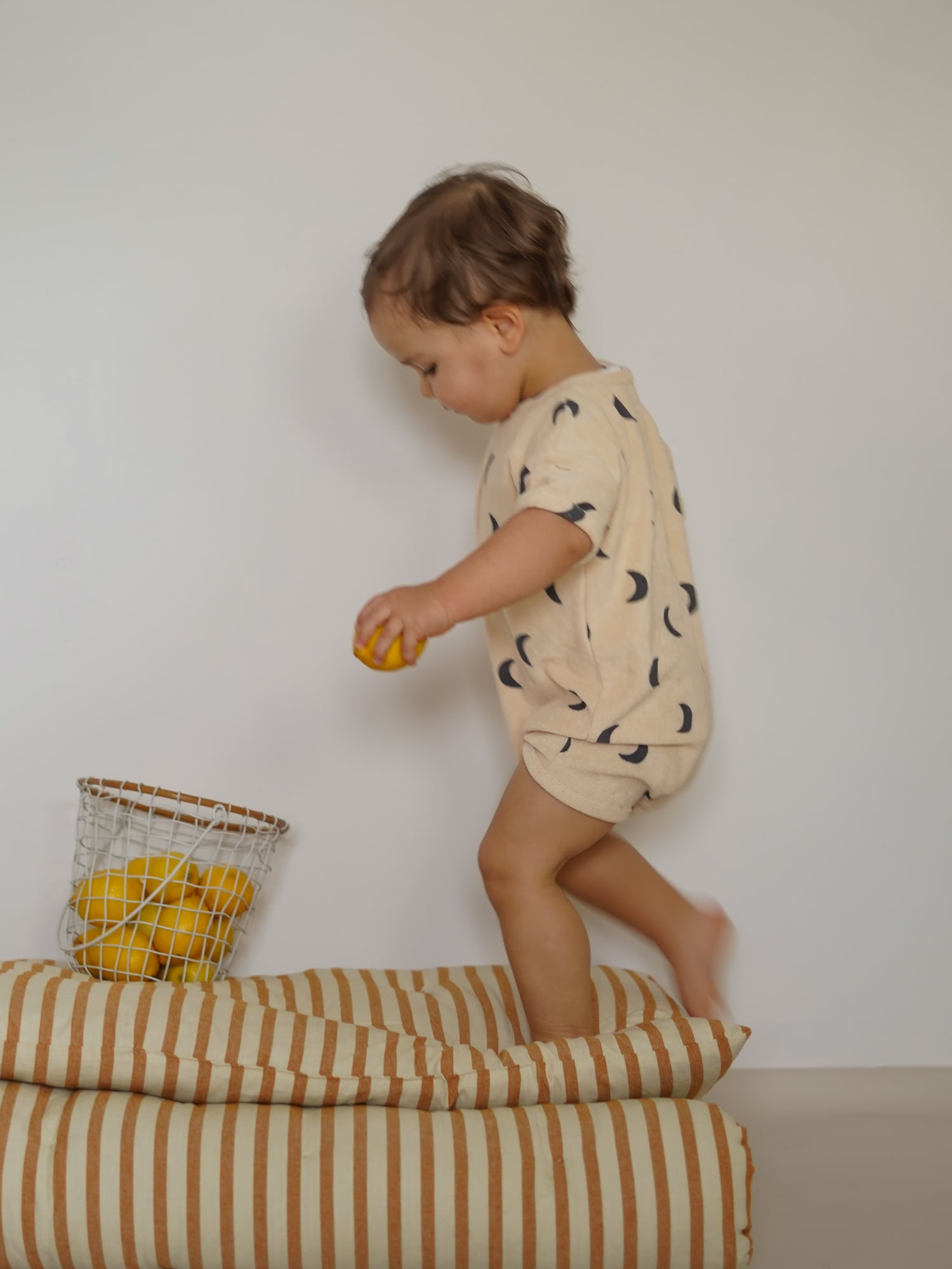 toddler wearing pebble midnight terry beach romper