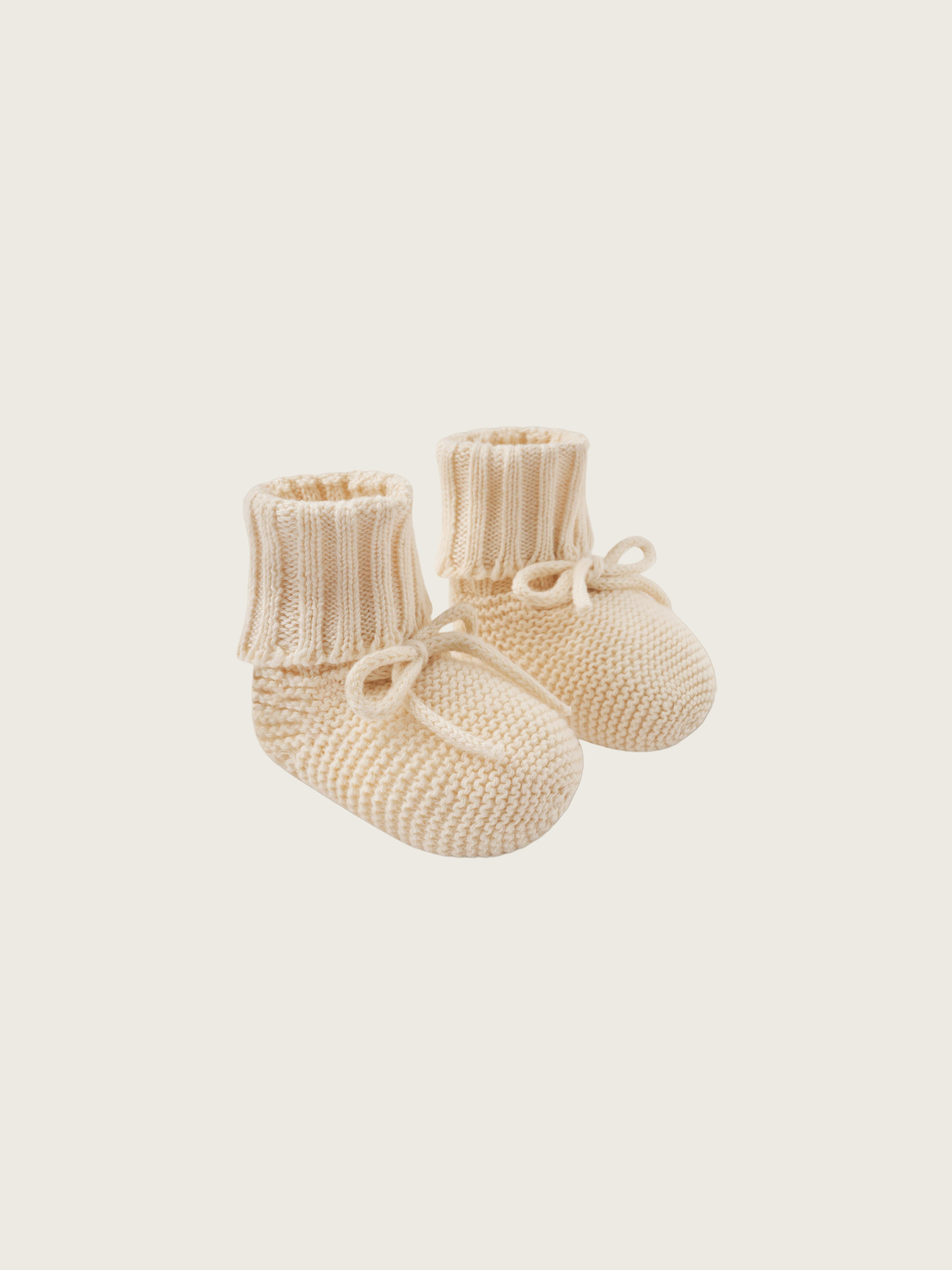 baby and toddler undyed cotton knitted booties in cream with ribbons