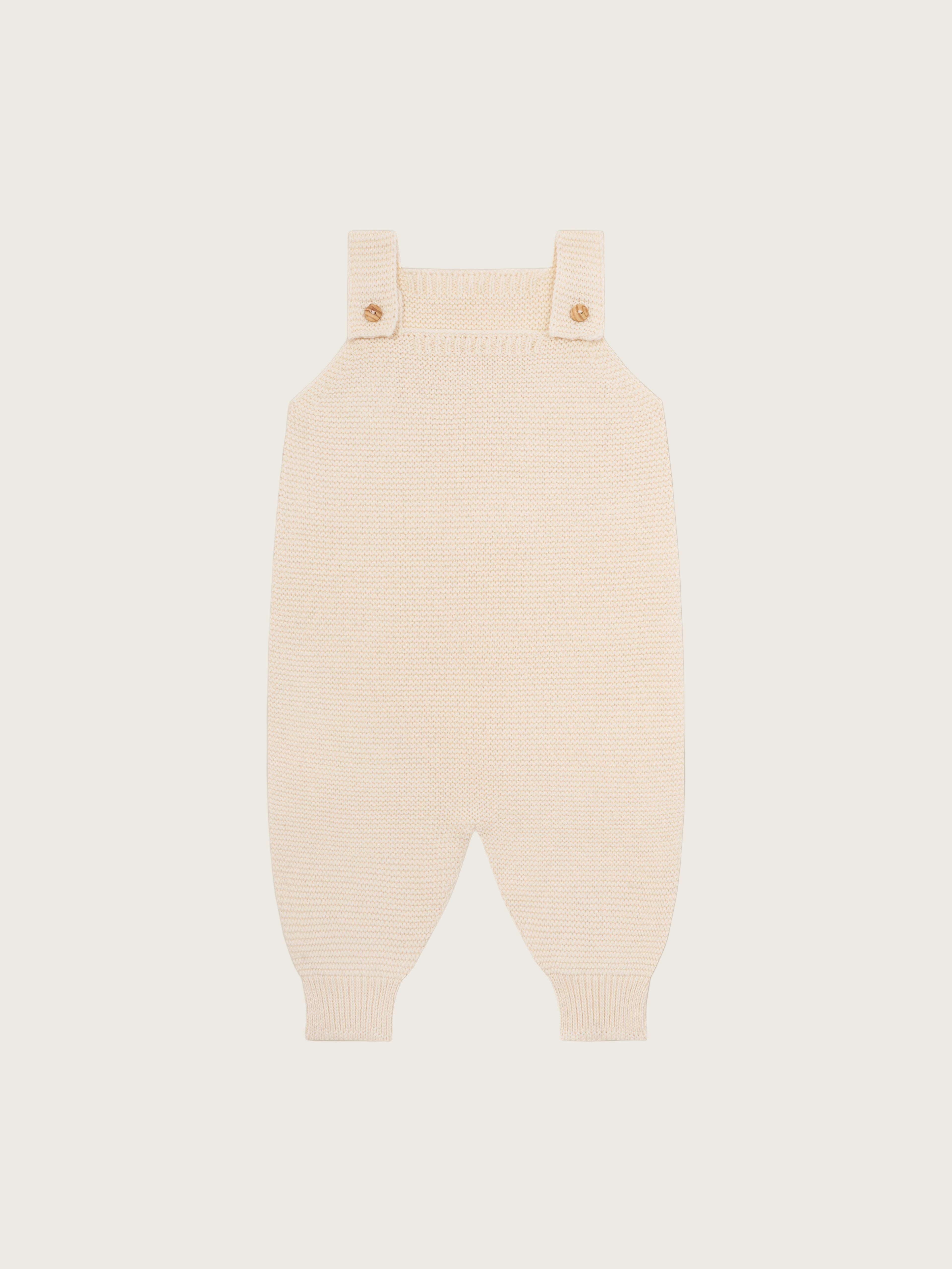 baby and toddler undyed cotton knitted salopette in cream with wooden buttons
