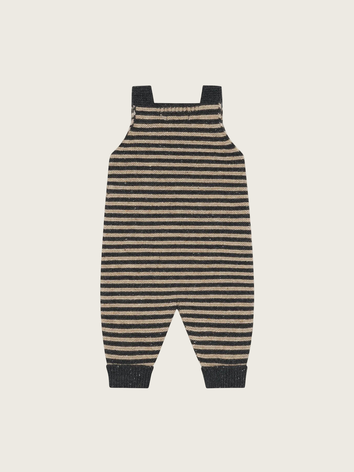 A pair of infant overalls with horizontal black and beige stripes, featuring dark ribbed shoulder straps, leg cuffs, and a footless cuffed bottom, shown flat on a light cream background.