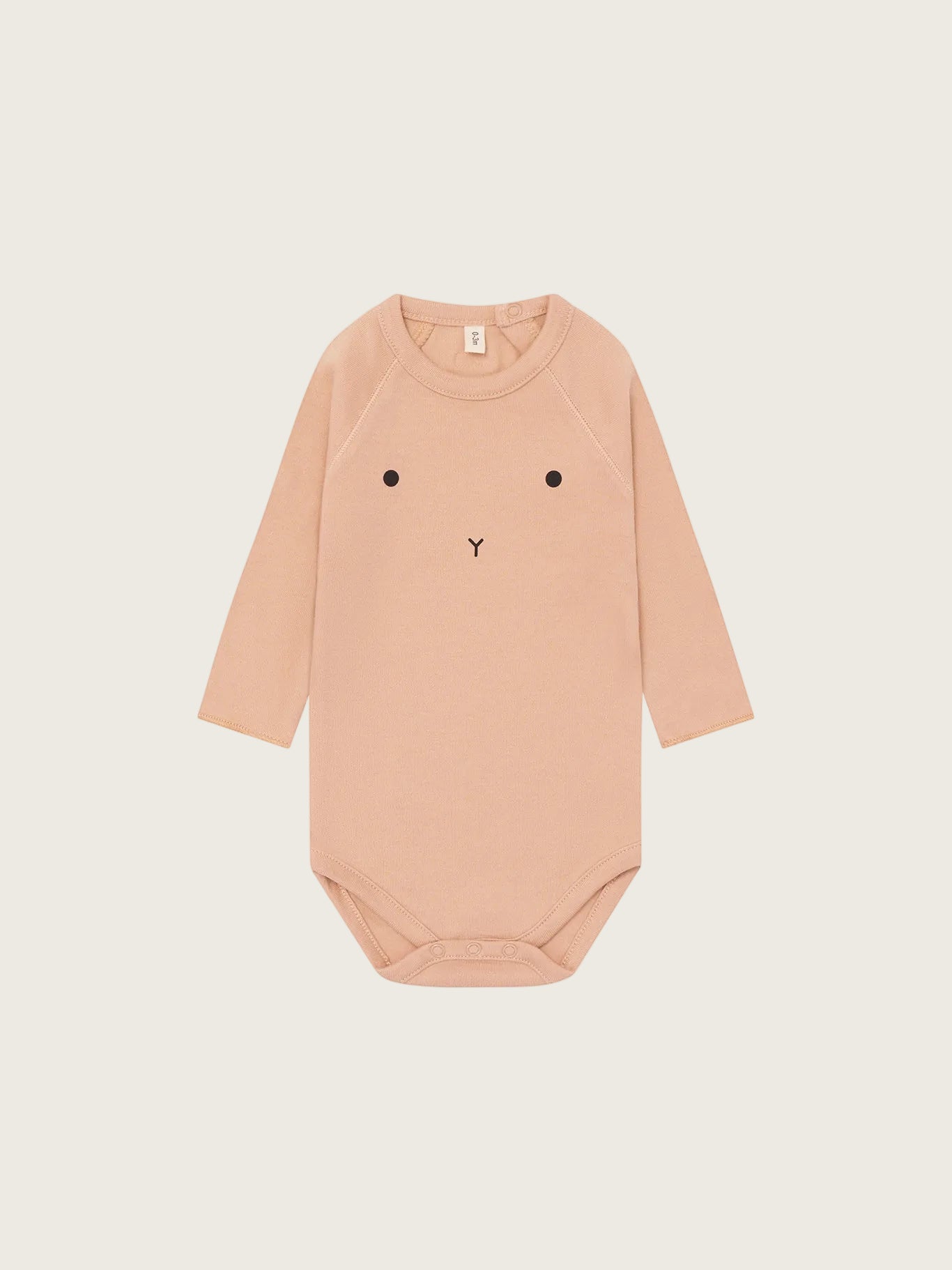 Beige baby bodysuit with a face design on a white background