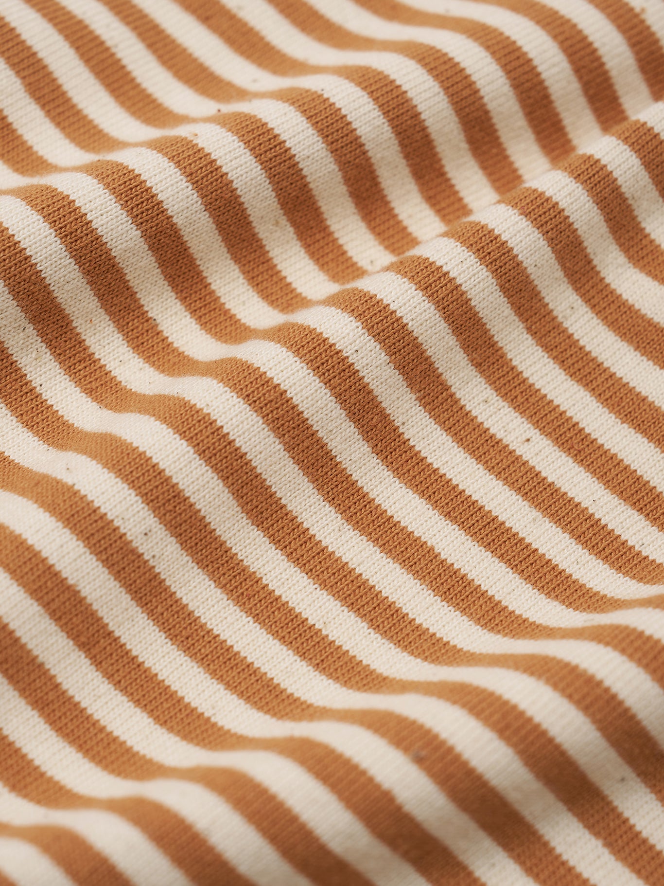 Close-up of fabric with copper and white wavy stripes
