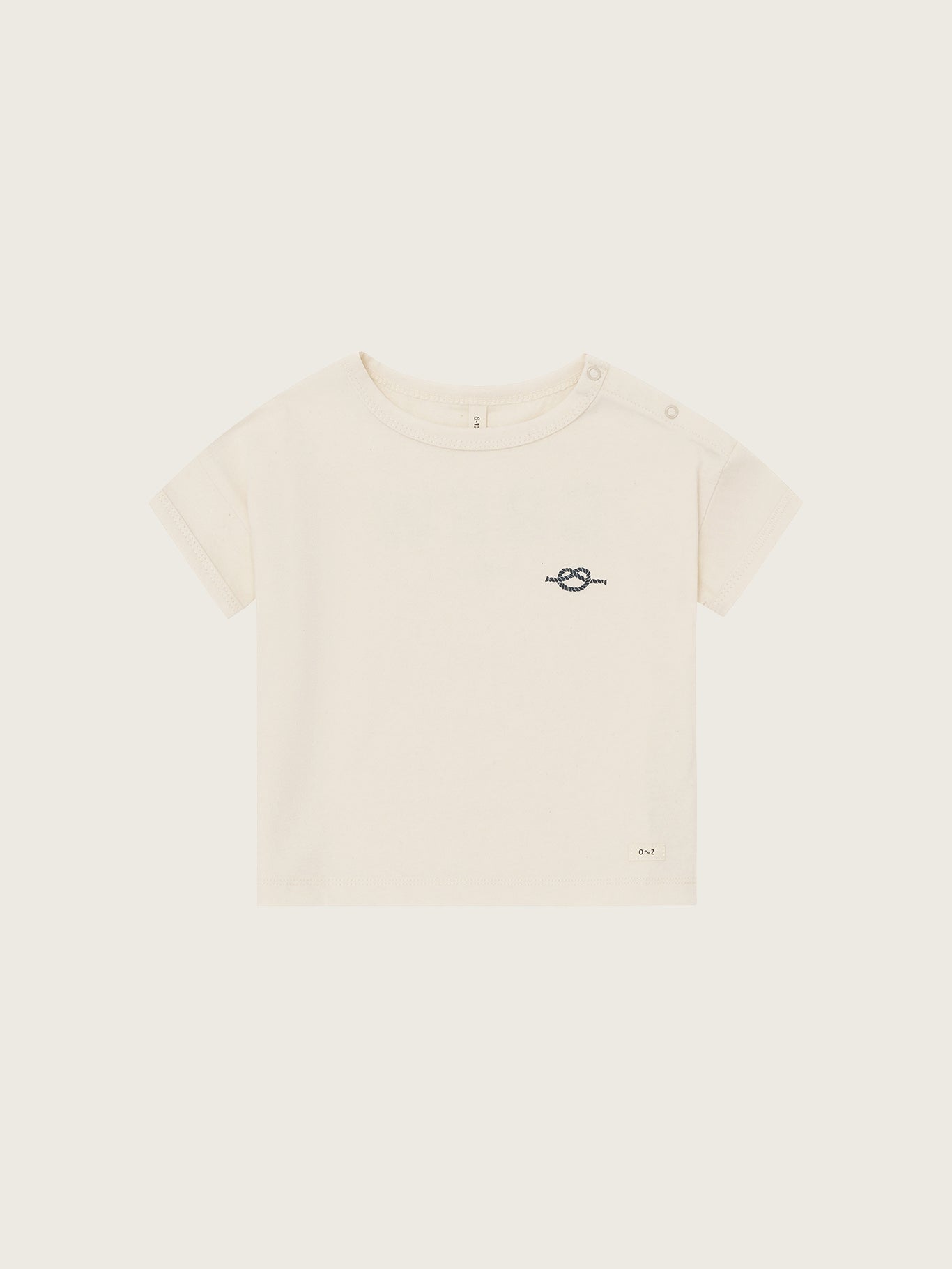 Beige t-shirt with a small logo on a white background