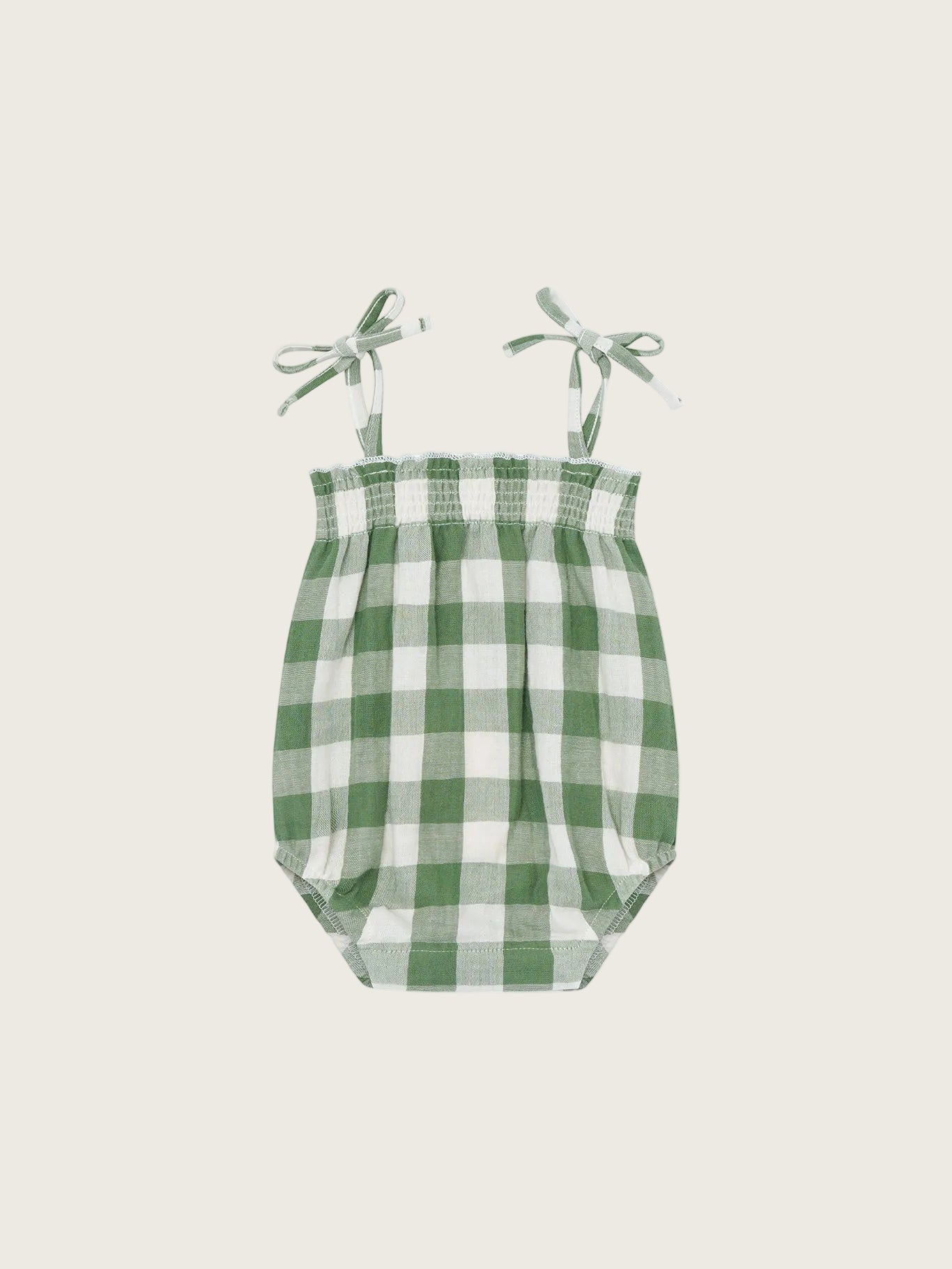 Green and white checkered baby bodysuit with straps on a white background