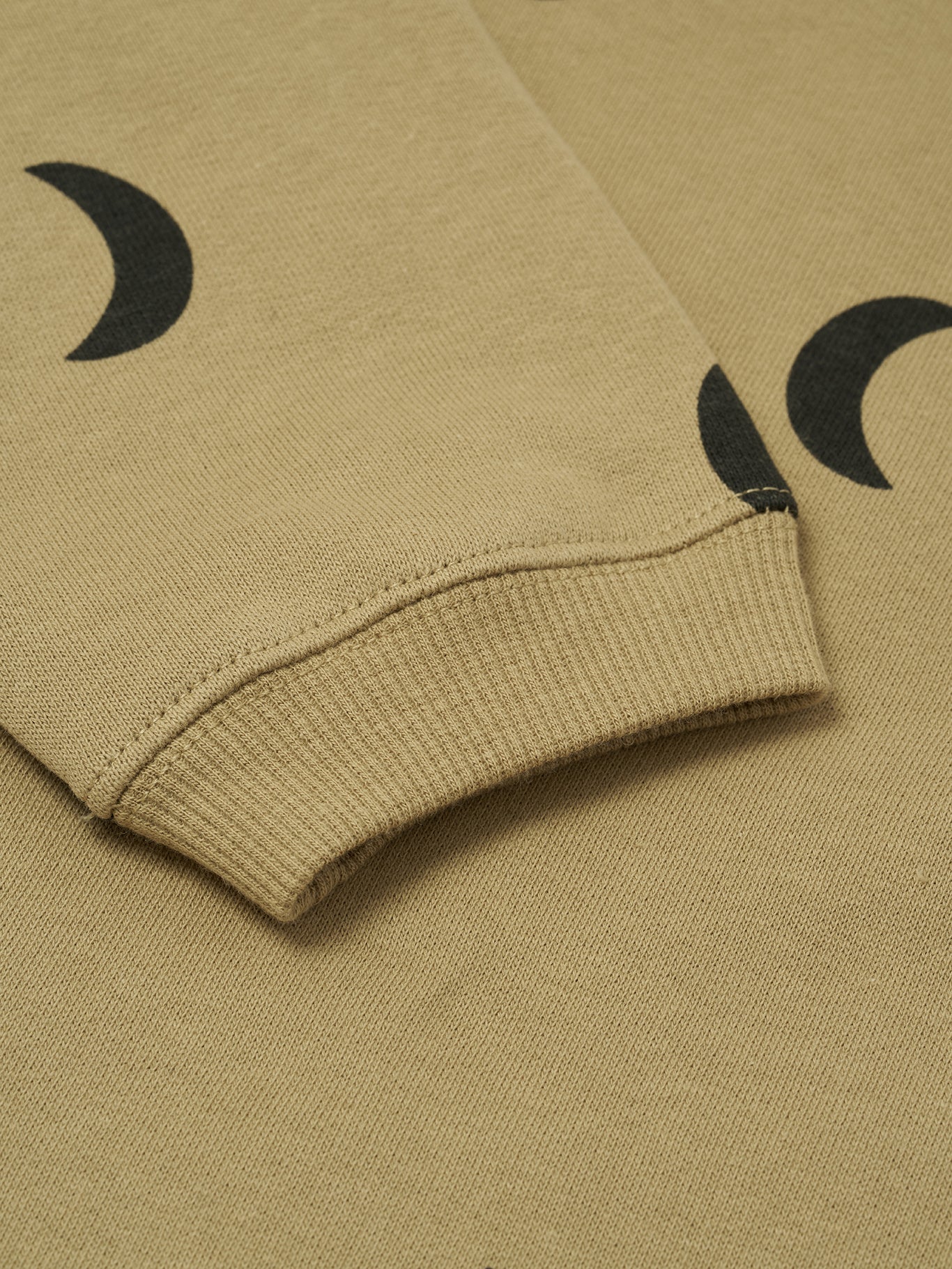 close up of baby and toddler dusky beige organic cotton boxy sweatshirt with black crescent moon print
