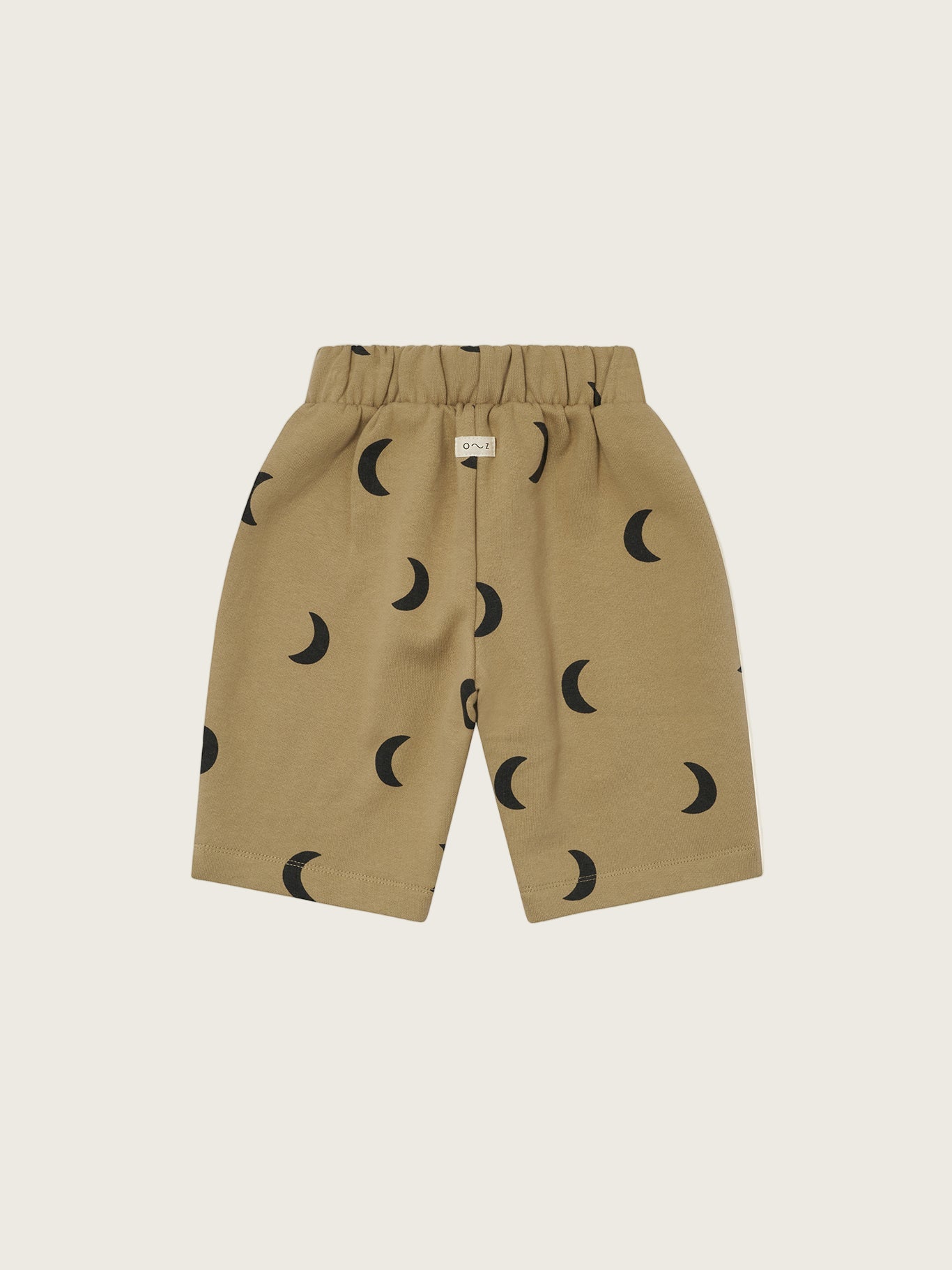 baby and toddler dusky beige trousers with black crescent moon print and elastic waistband