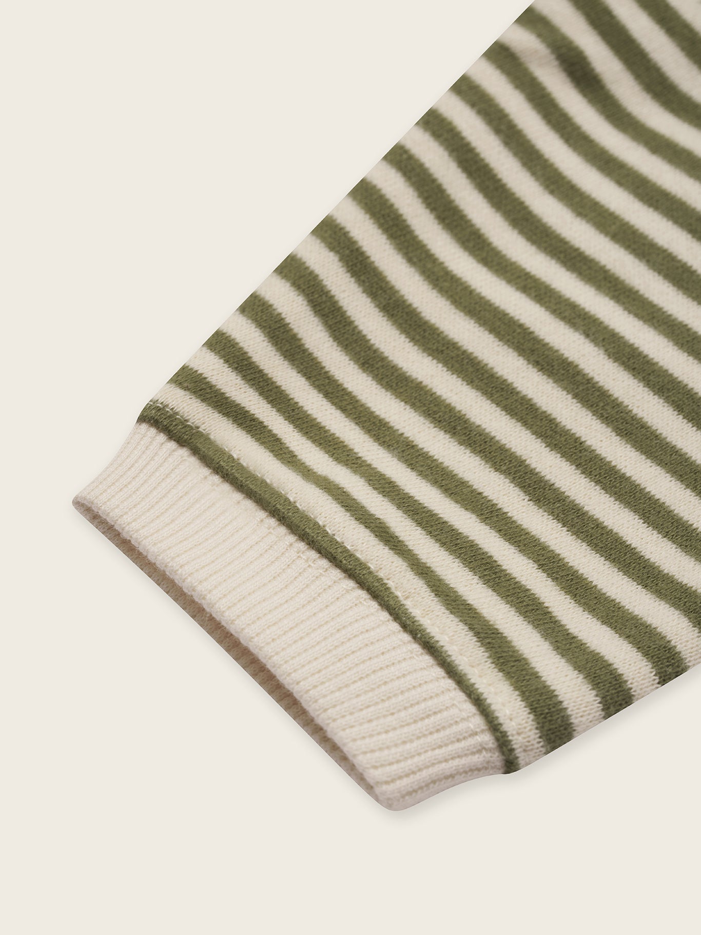 close up of baby and toddler organic cotton sweatshirt in green and white stripes