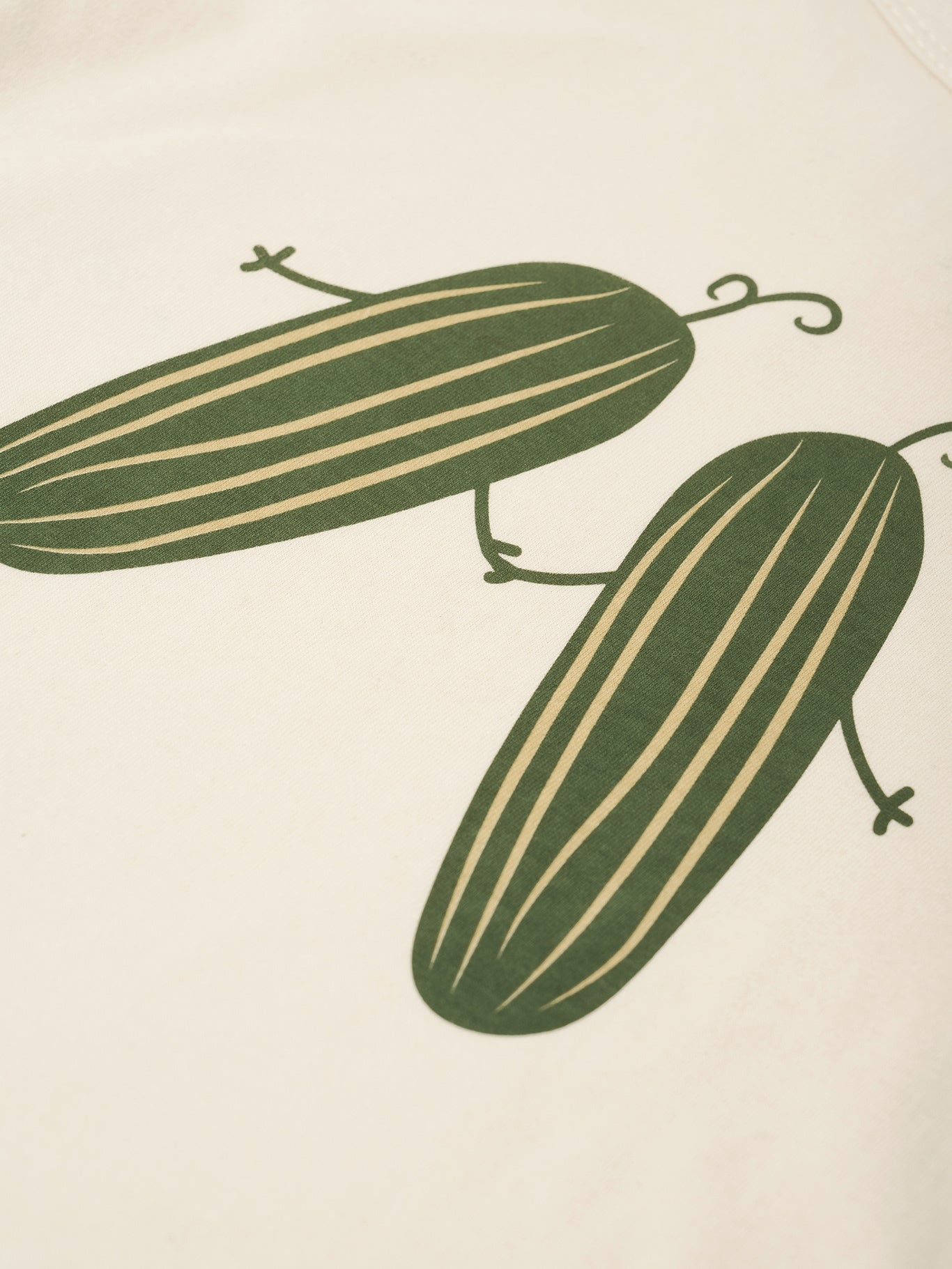 Two green cucumbers on a beige background