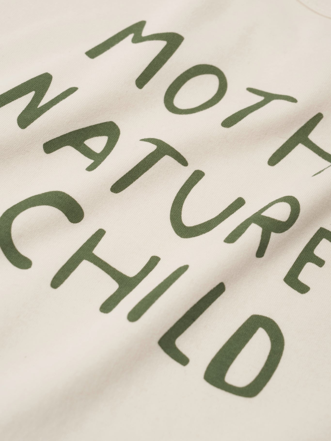 Text 'MOTHER NATURE CHILD' printed on a beige background