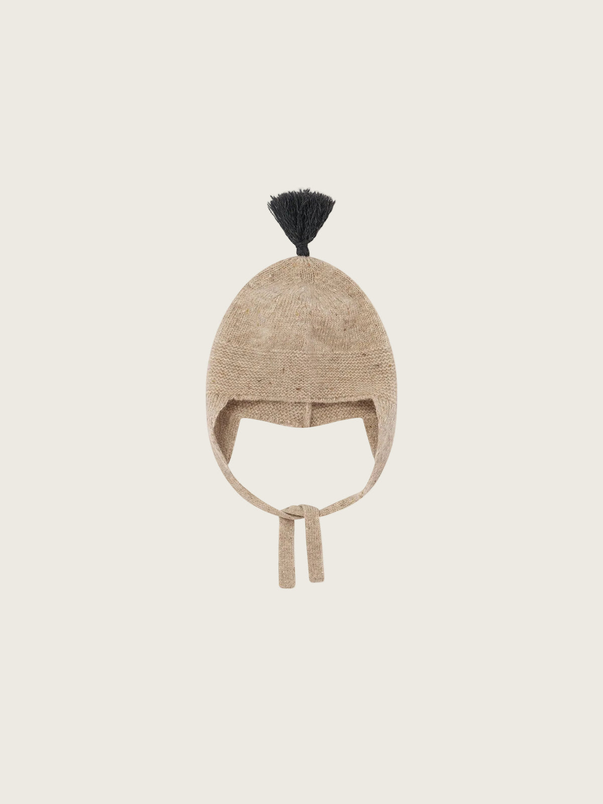 A beige knit winter hat with ear flaps and a small black tassel on top, shown against a plain white background.
