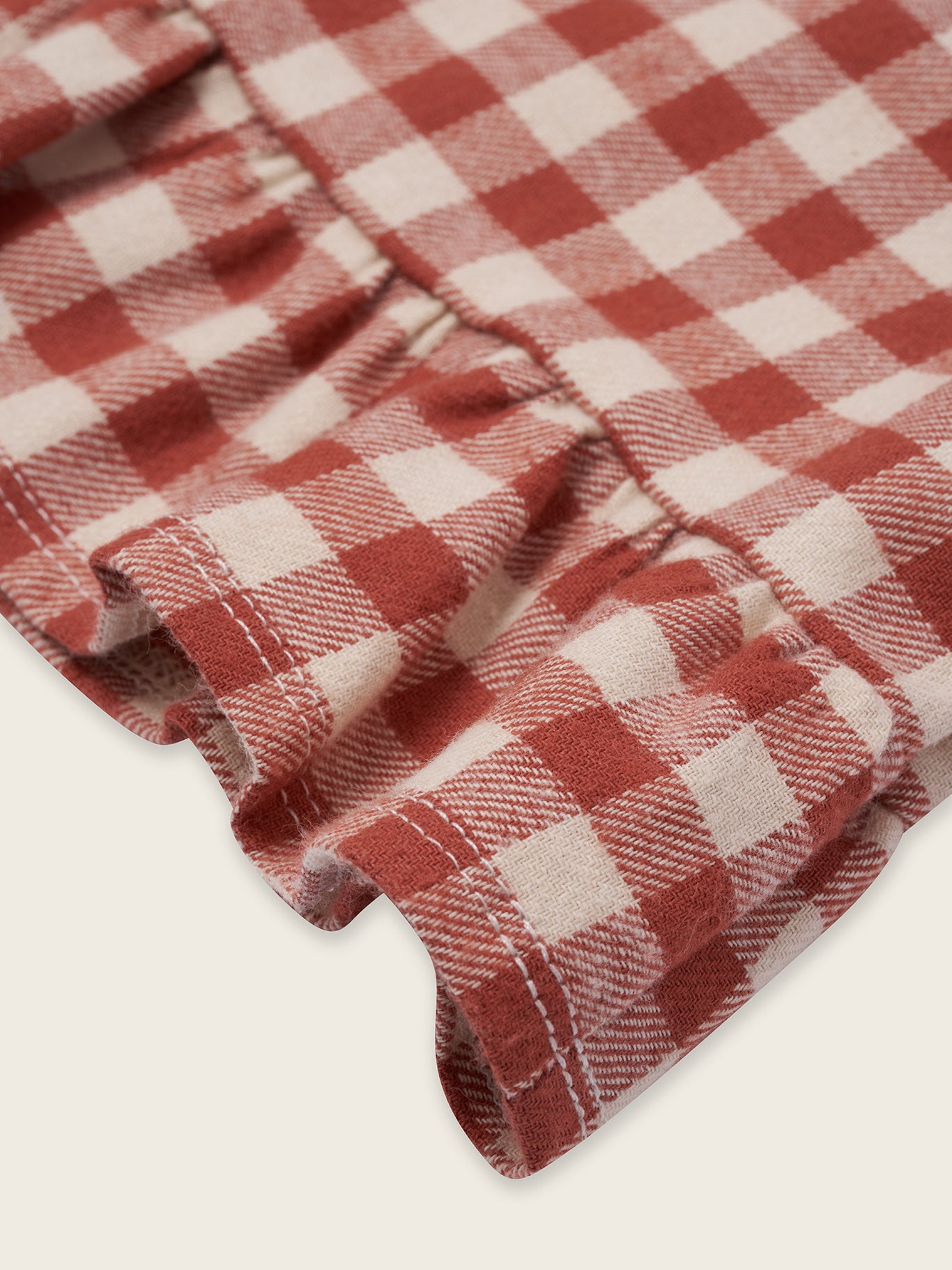 close up of toddler red and cream checkered gingham flannel culottes with frill hems