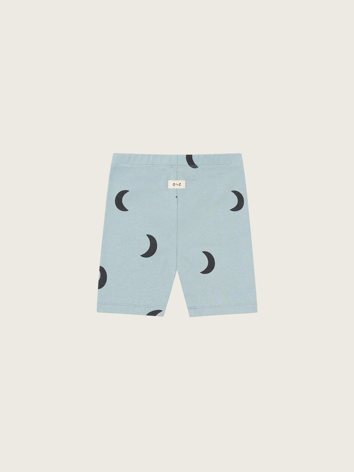 Light blue shorts with black crescent moon pattern on a white background