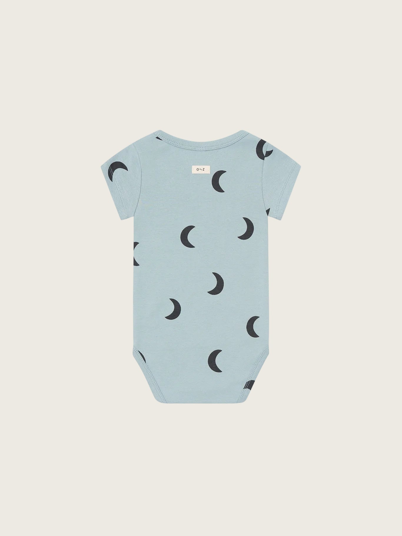Light blue baby onesie with crescent moon pattern on a white background