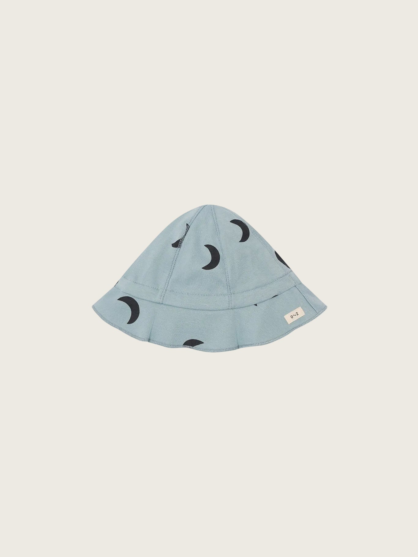 Light blue bucket hat with black moon patterns on a white background