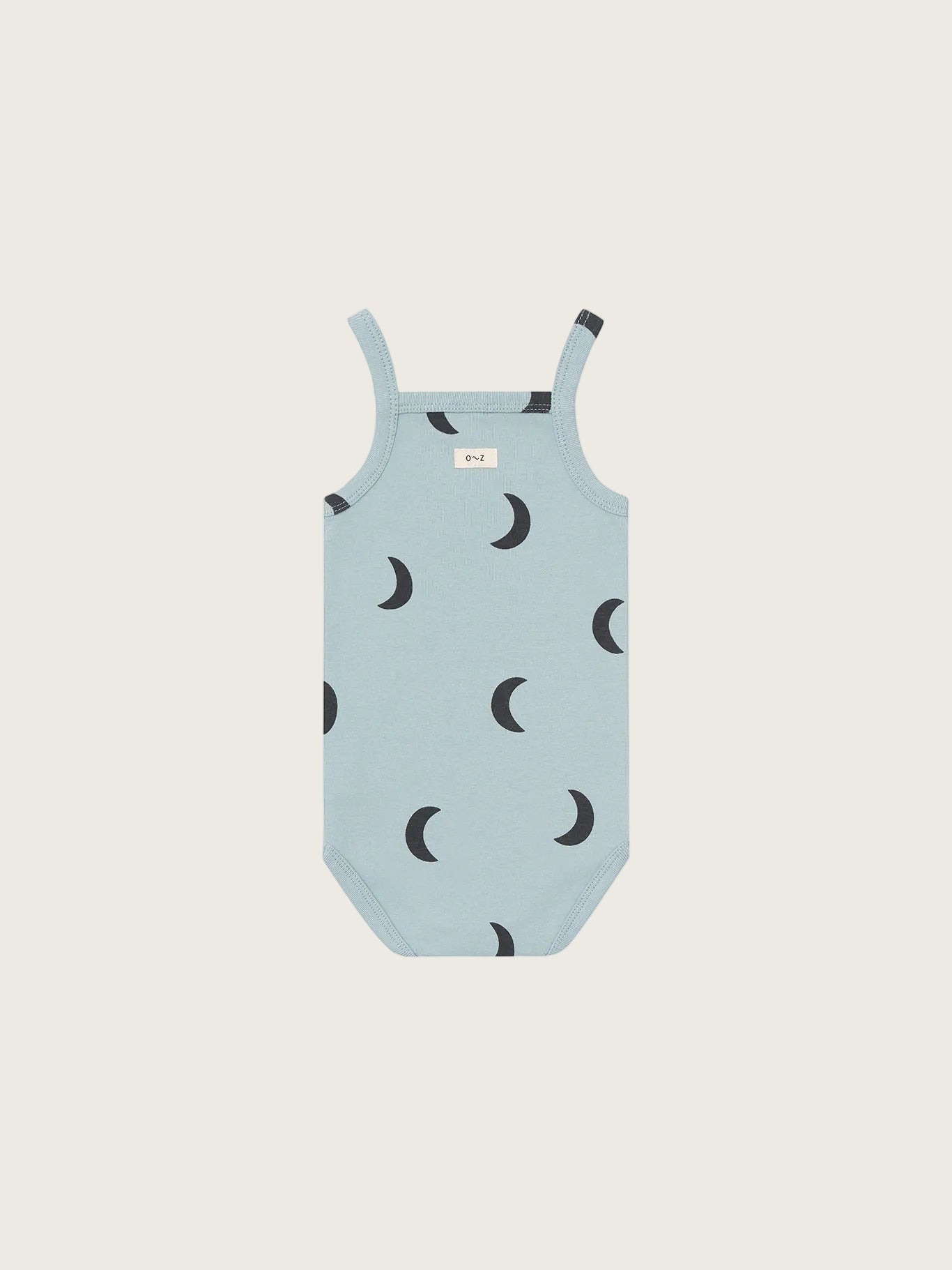 Light blue swimsuit with black crescent moon pattern on a white background