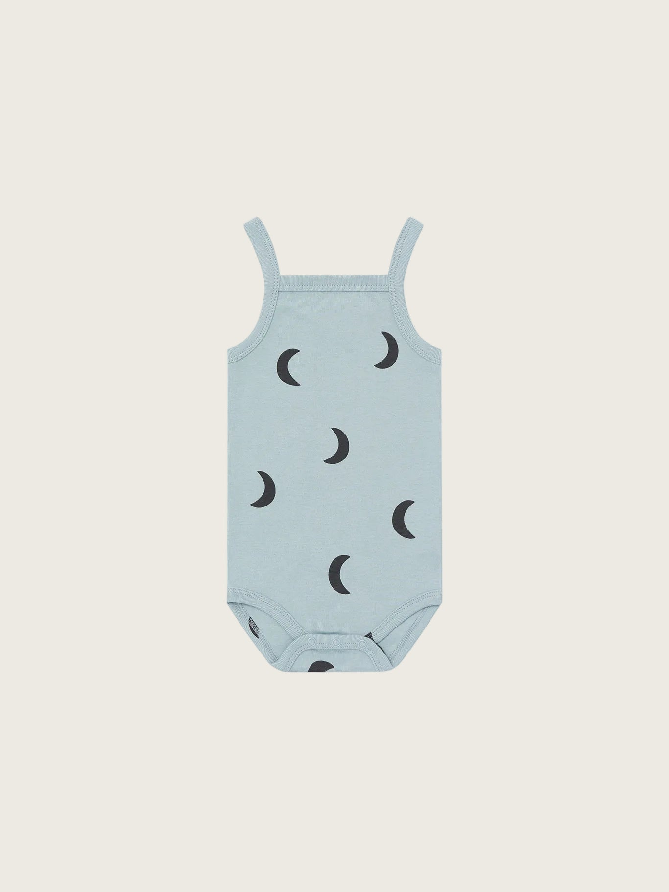 Light blue baby romper with black moon patterns on a white background