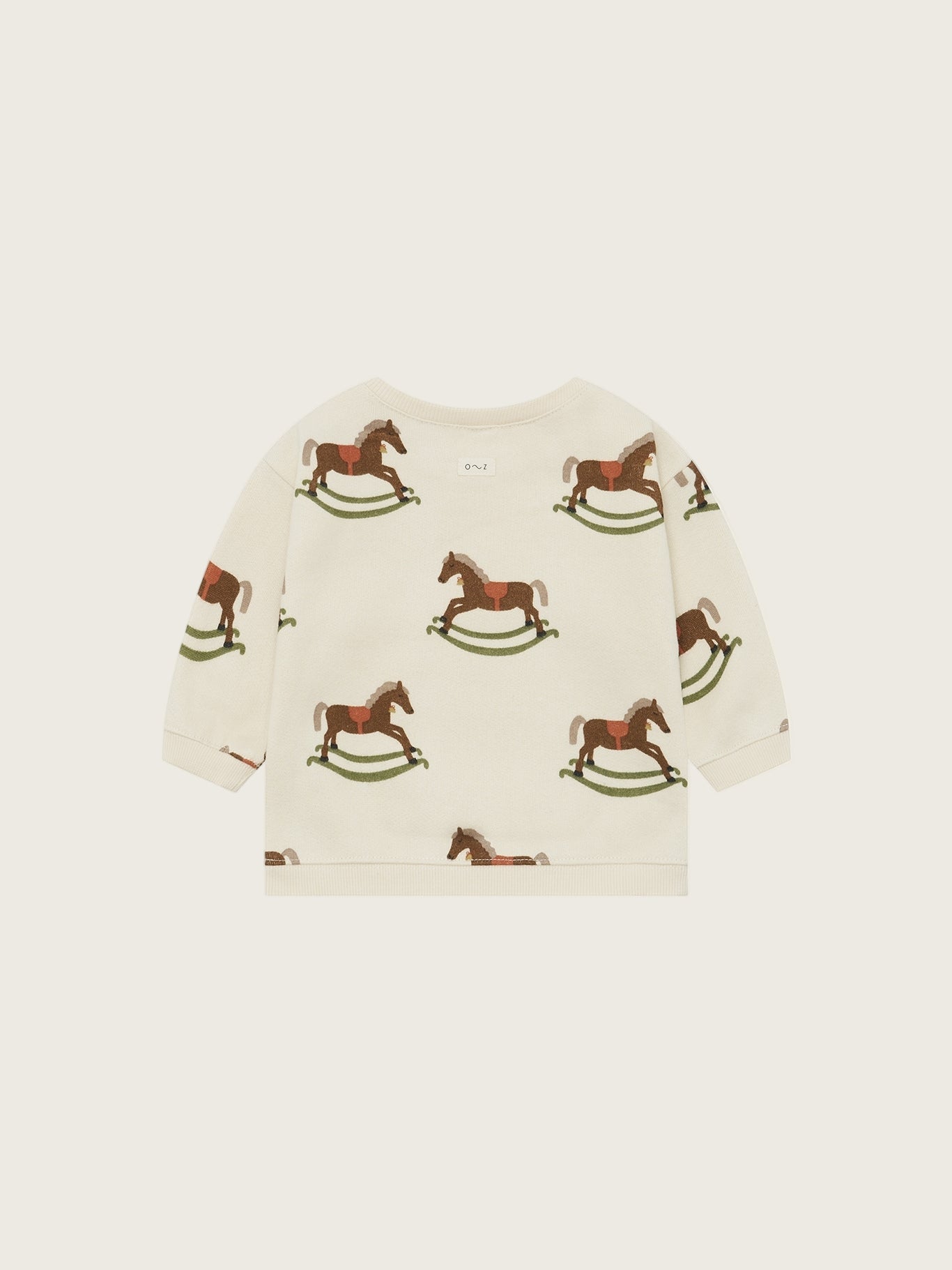 Children's sweater with rocking horse pattern on a white background
