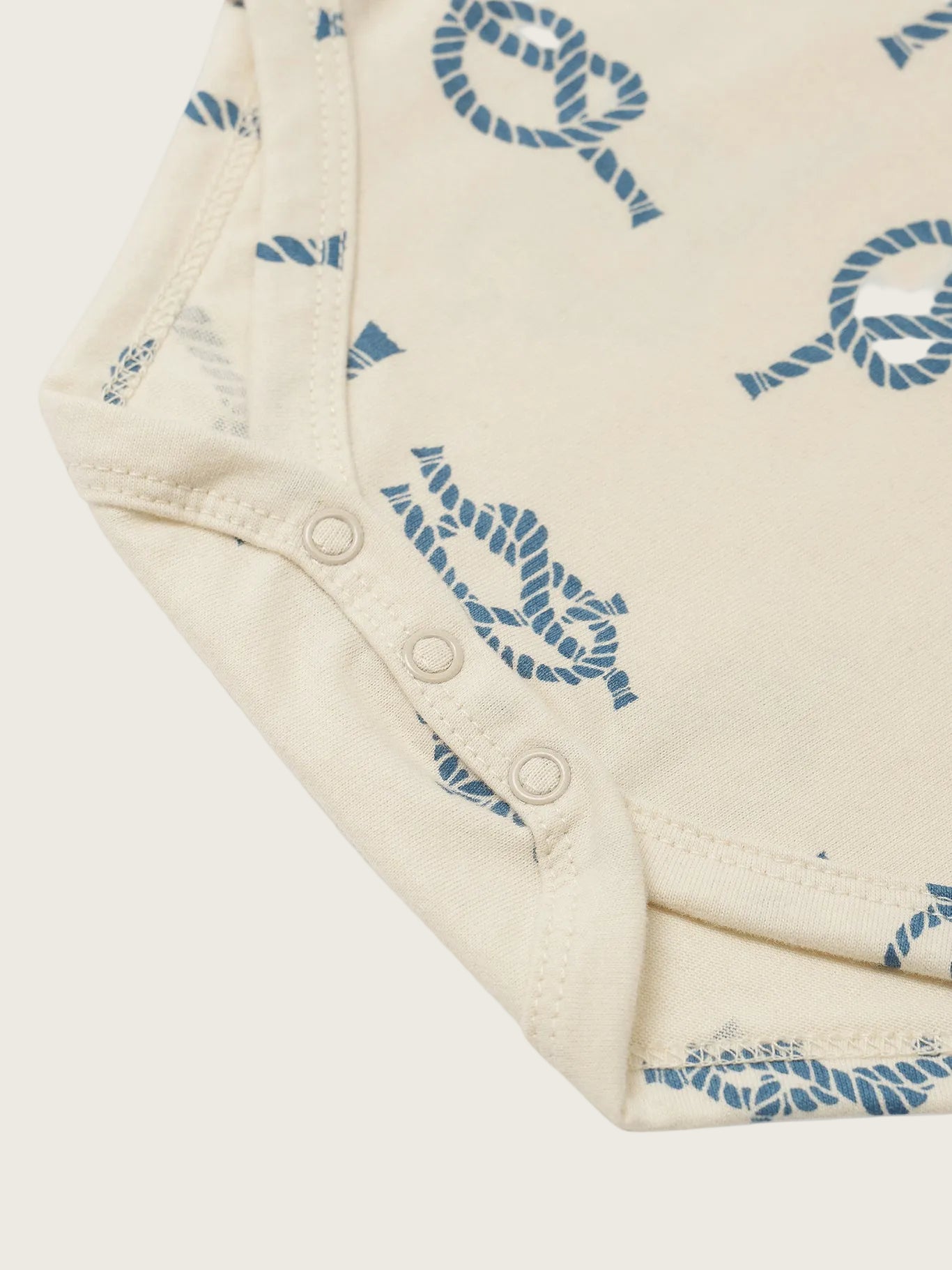 Close-up of a folded piece of fabric with blue patterns on a white background