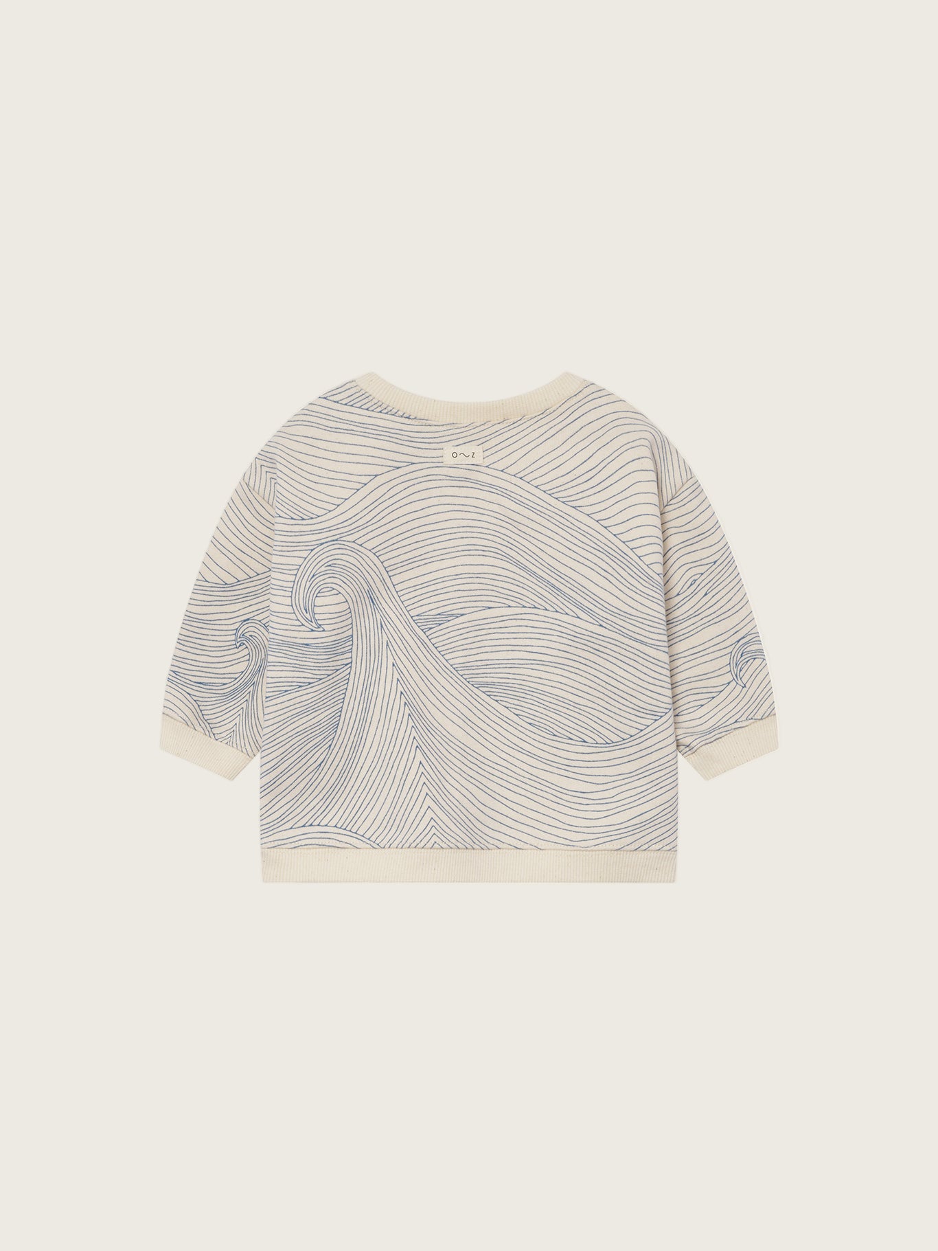 baby cream undyed cotton sweatshirt with shoulder buttons and blue Seascape line-drawn ocean waves