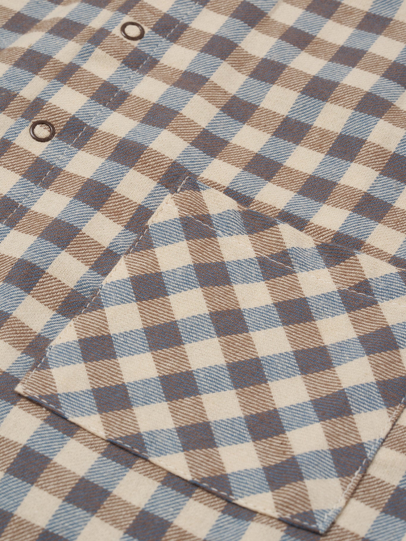 close up of gingham lodge shirt in cream & blue with peter pan collar, patch pockets & balloon sleeves