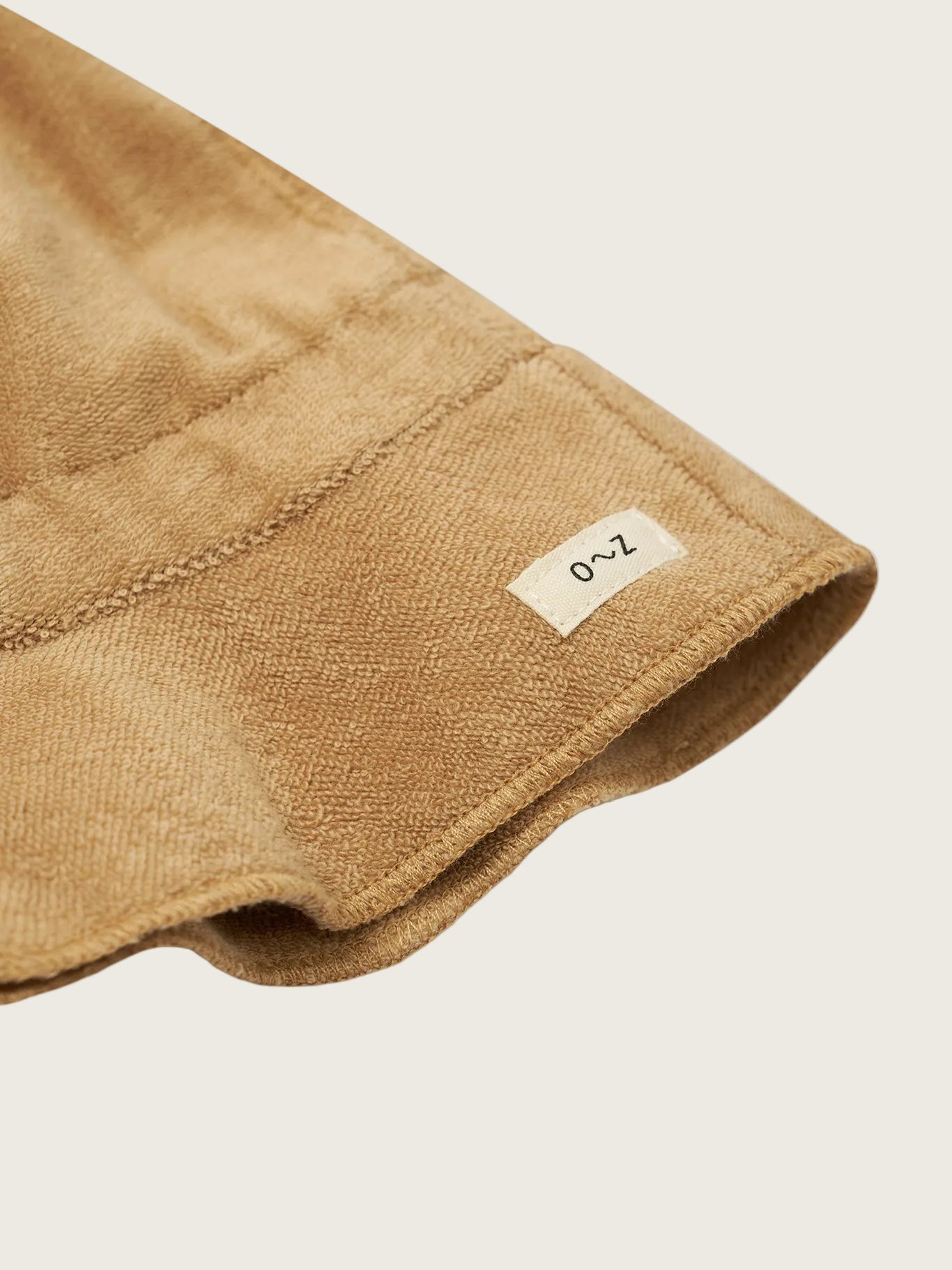 Brown towel with a label on a white background