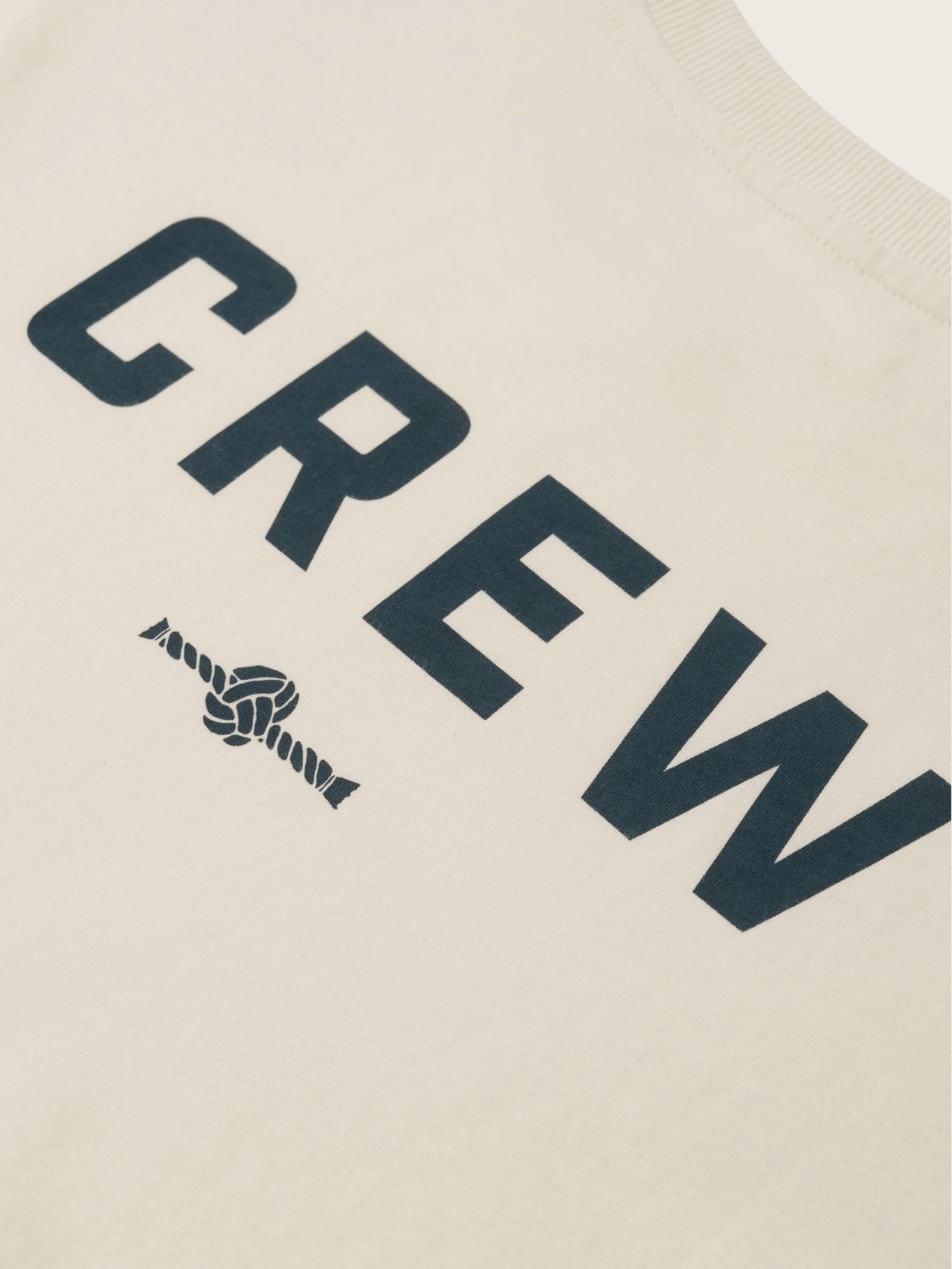 Text 'CREW' with a knot design on a beige background