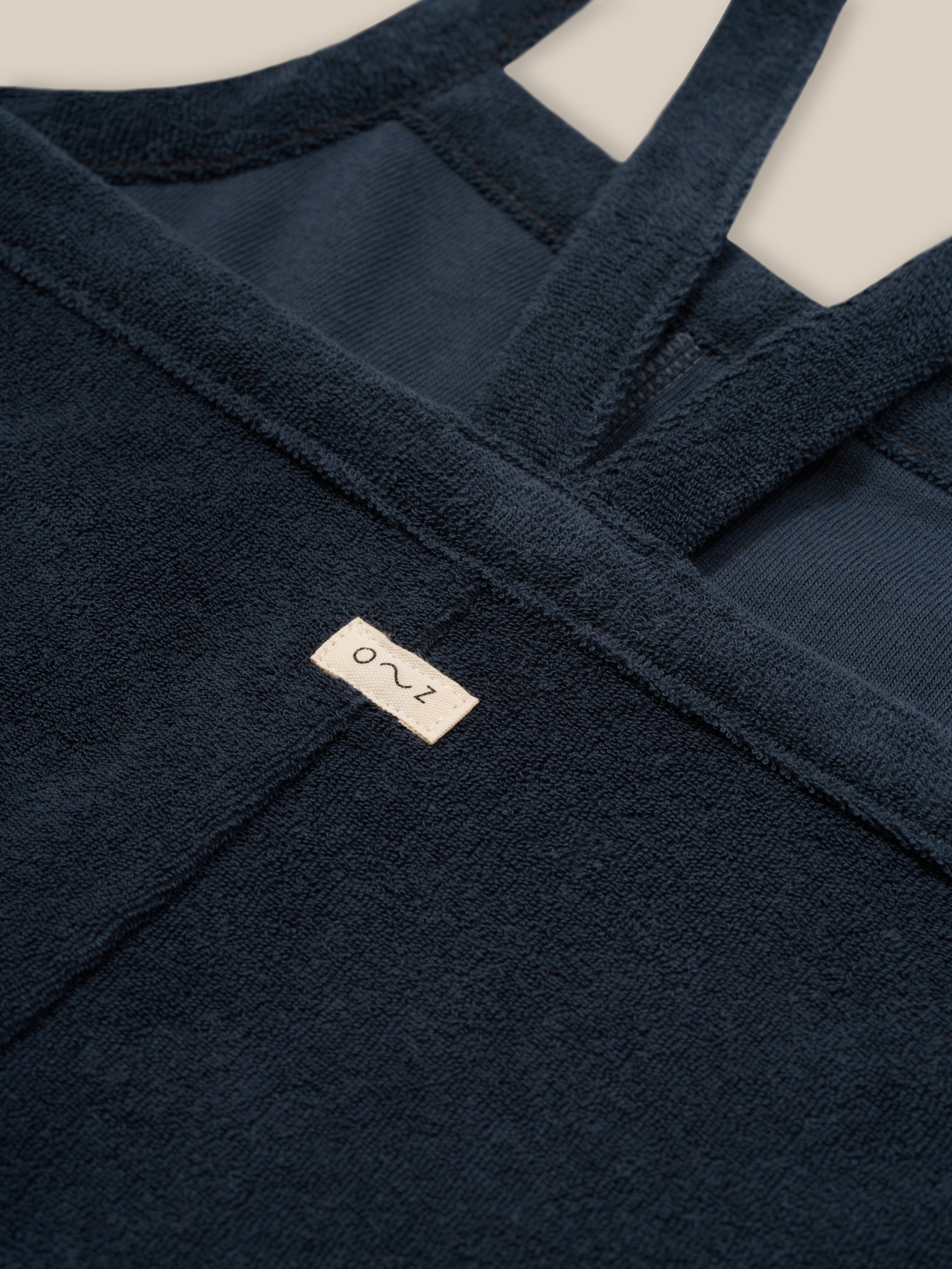 close up of toddler navy boxy cropped soft organic terry cotton dungarees