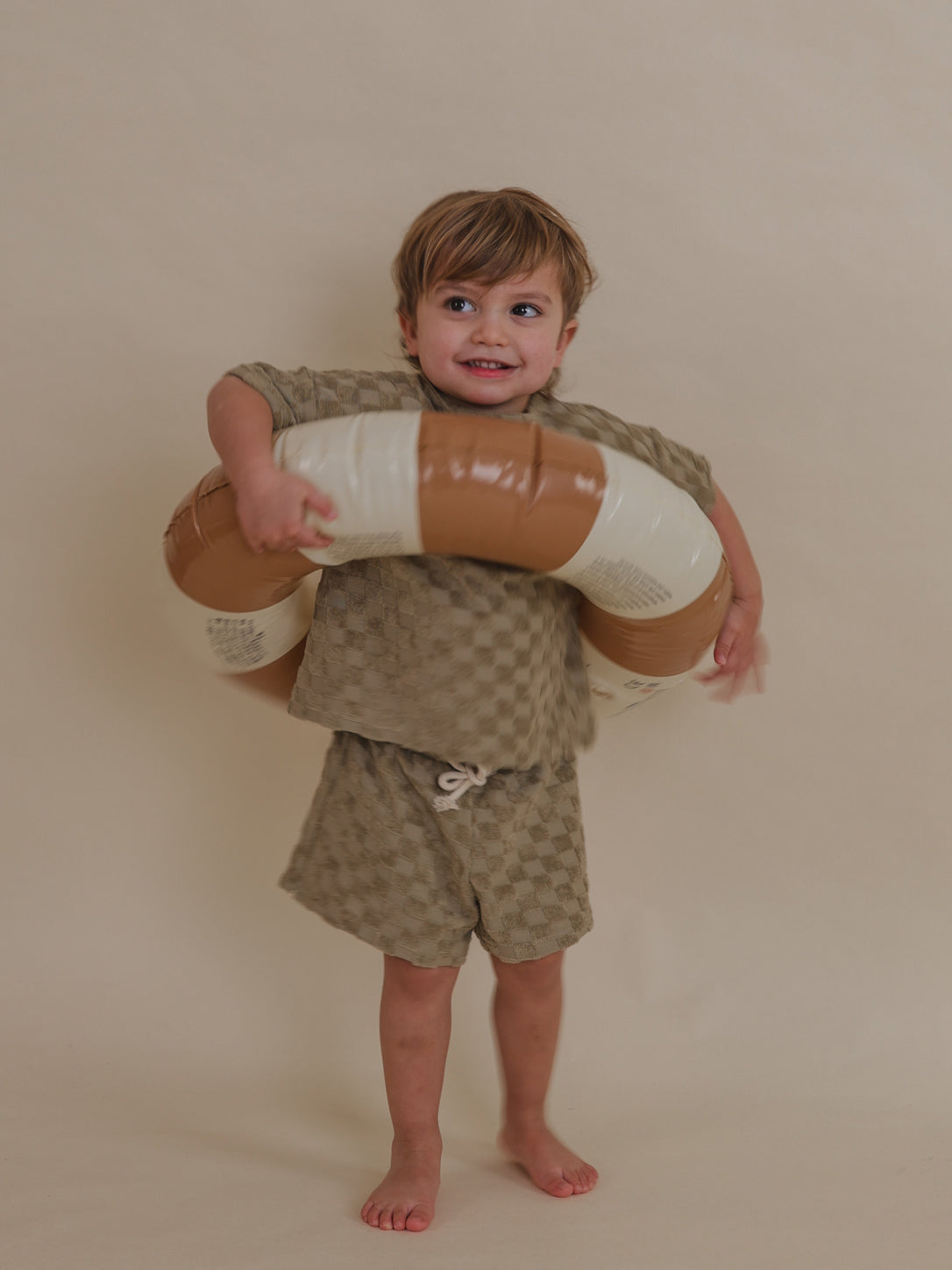 toddler in terry cotton dusky beige checkerboard rope shorts & matching top with pool ring