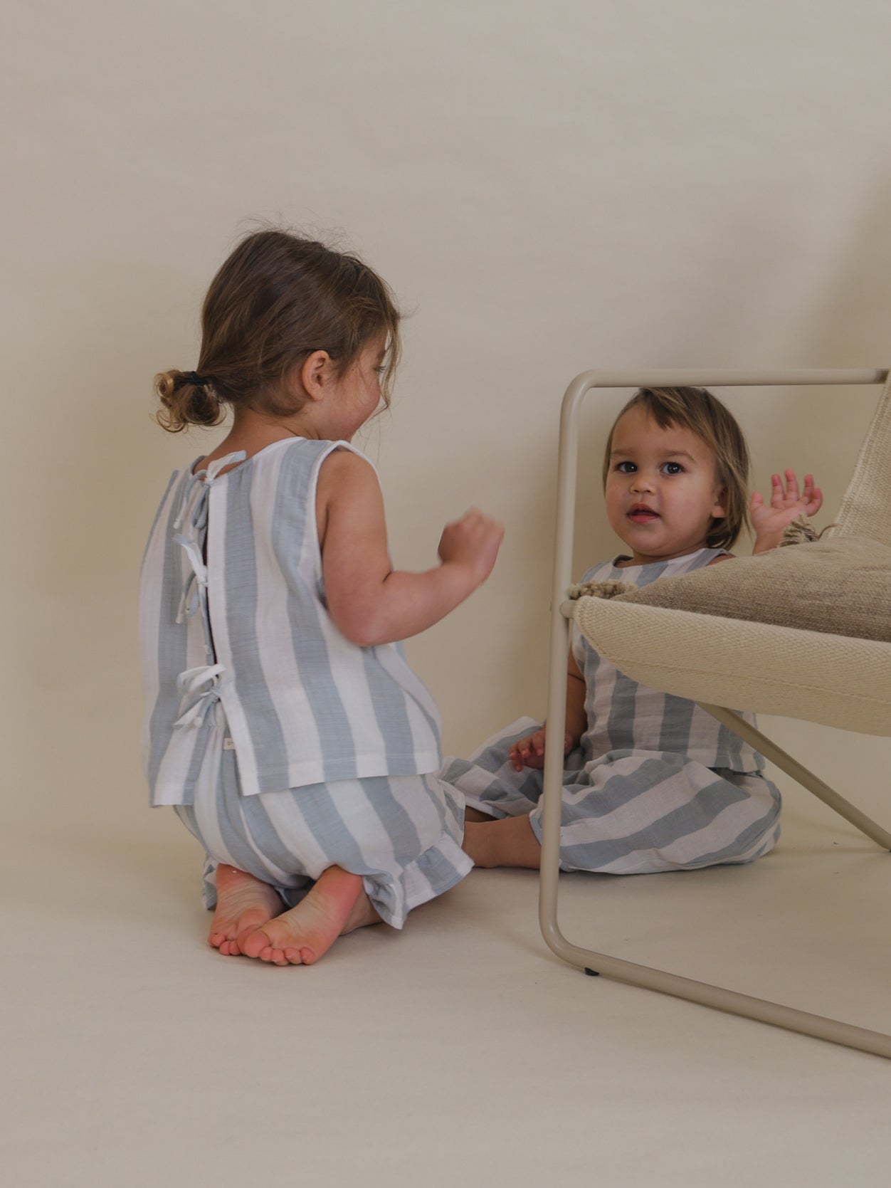 toddlers playing in matching blue striped sleeveless muslin ribbon-tie back top frill shorts & trousers