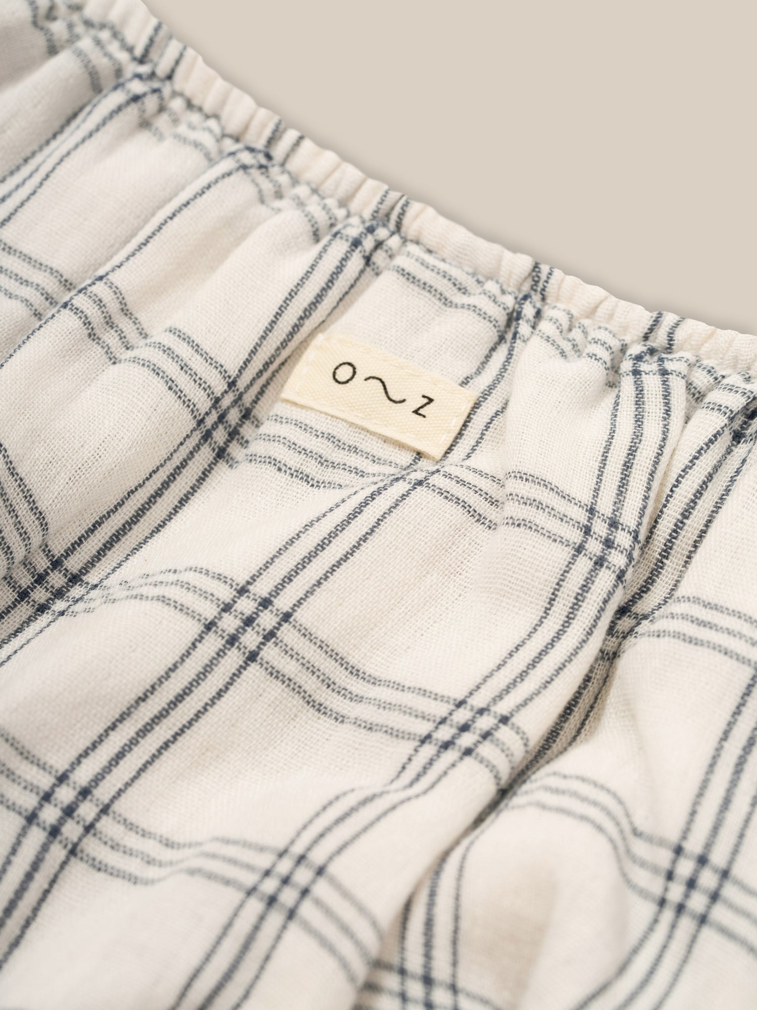 close up of baby & toddler muslin window check shortie with elasticated waist & leg openings