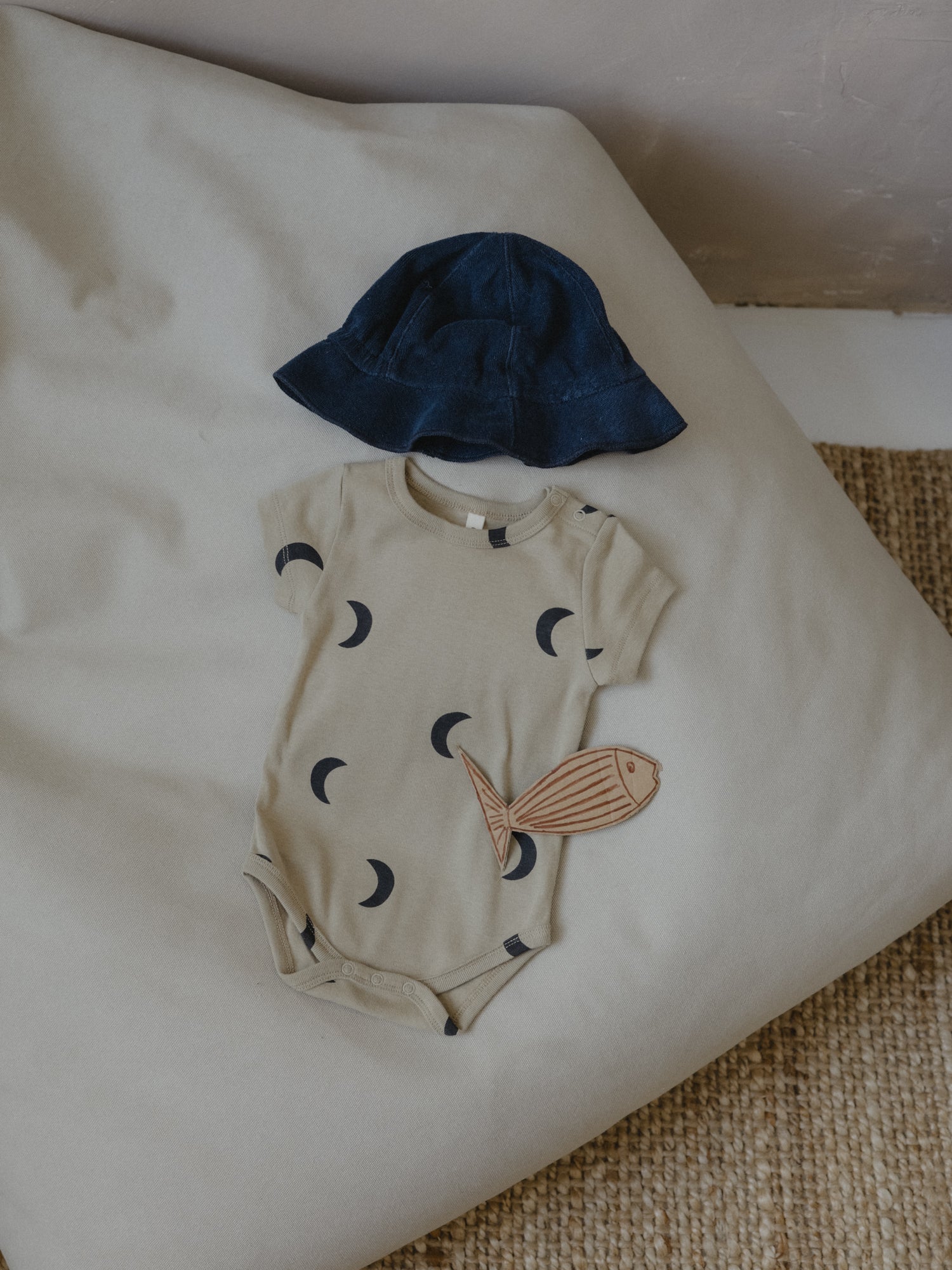 baby dusky beige organic ribbed cotton short sleeved bodysuit with black moon and navy terry sun hat