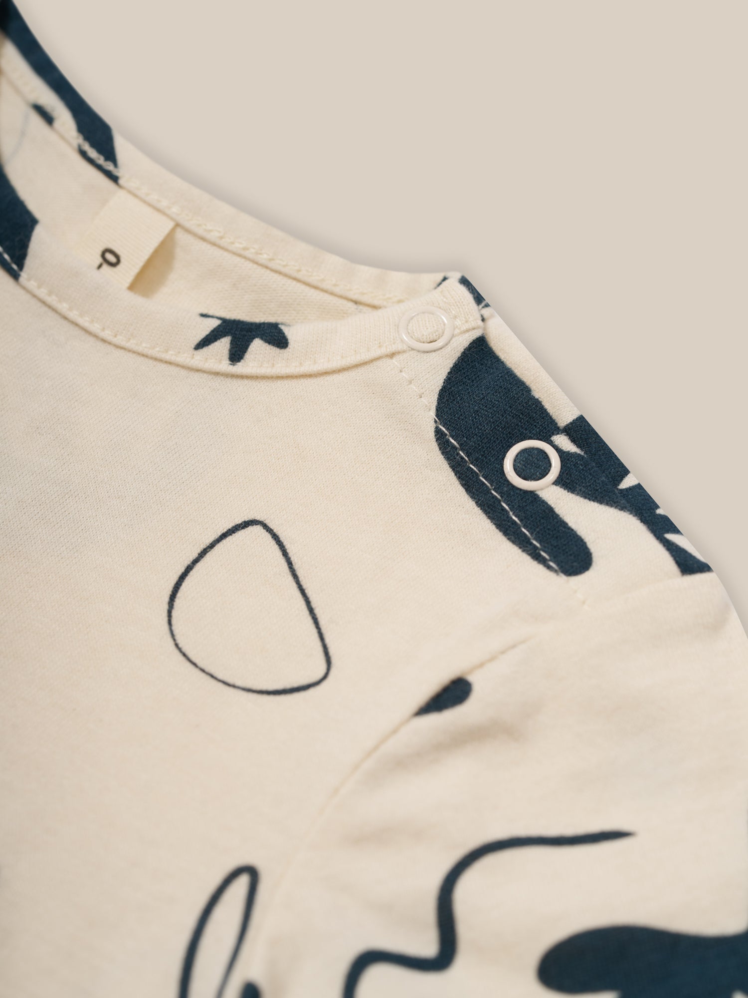 close up of baby undyed cotton crew neck t-shirt with ocean print & shoulder poppers