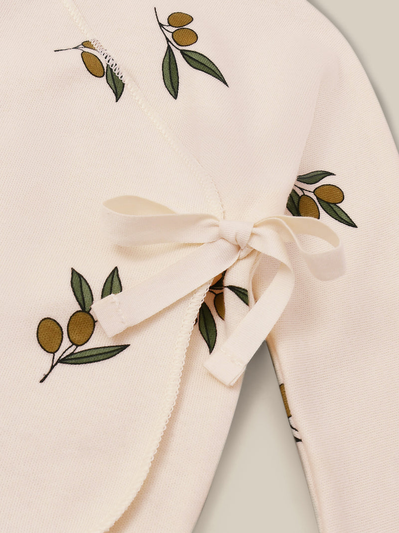 close up of cotton kimono in cream with olives and bow