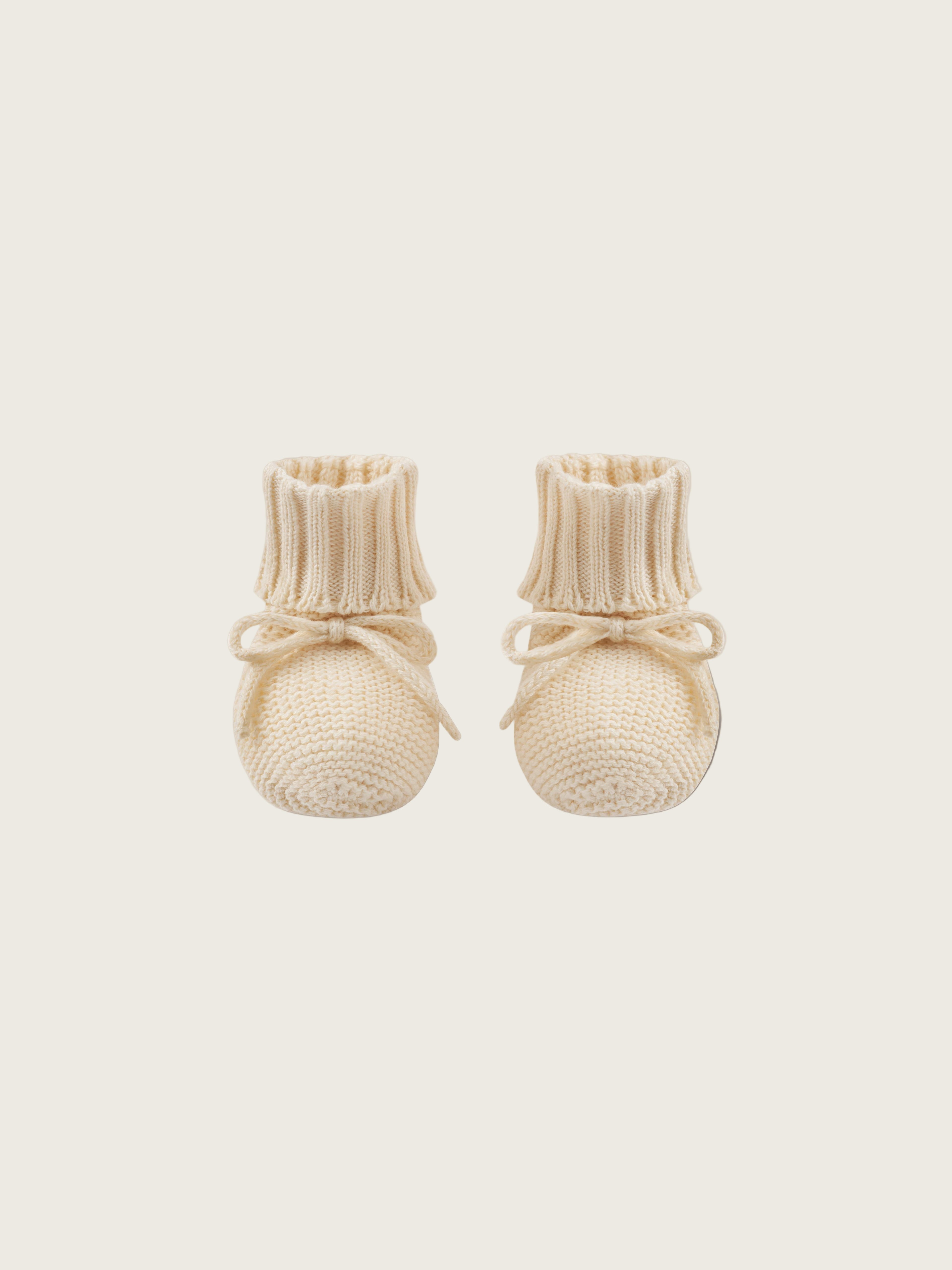 baby and toddler undyed cotton knitted booties in cream with ribbons