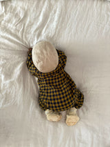 baby in navy & yellow gingham flannel onesie bonnet & cream booties crawling on bed