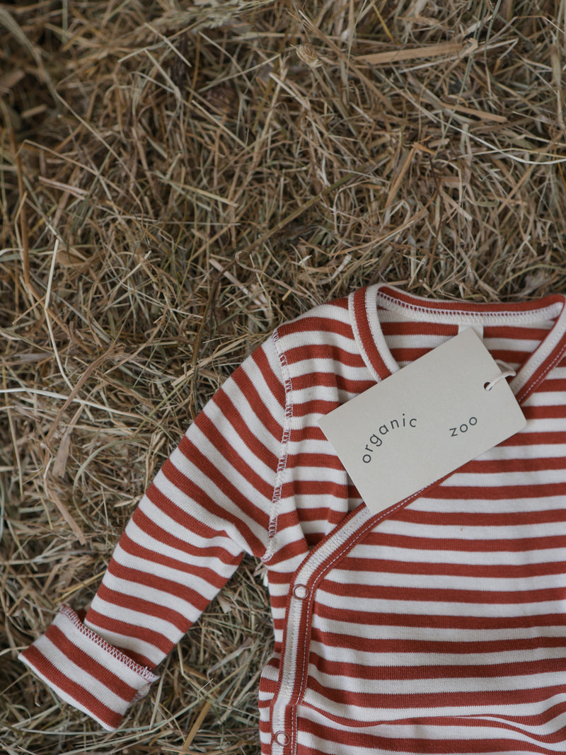 baby paprika red & white stripes wrap bodysuit with organic zoo tag on farm straw