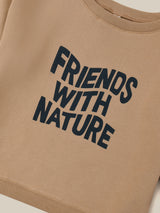 close up of brown sweater with FRIENDS WITH NATURE in wavy text across the front