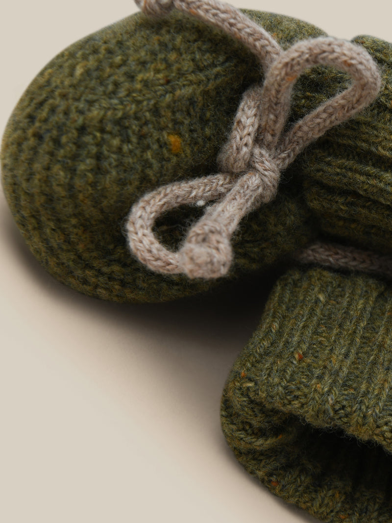 close up of wool booties in dark green with grey ribbons