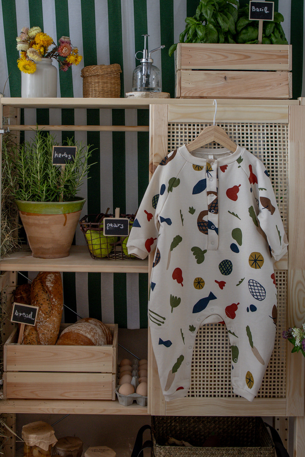 baby & toddler cream long-sleeve onesie with fruits vegetables & basket prints hanging on rattan cupboard