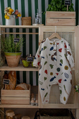 baby & toddler cream long-sleeve onesie with fruits vegetables & basket prints hanging on rattan cupboard