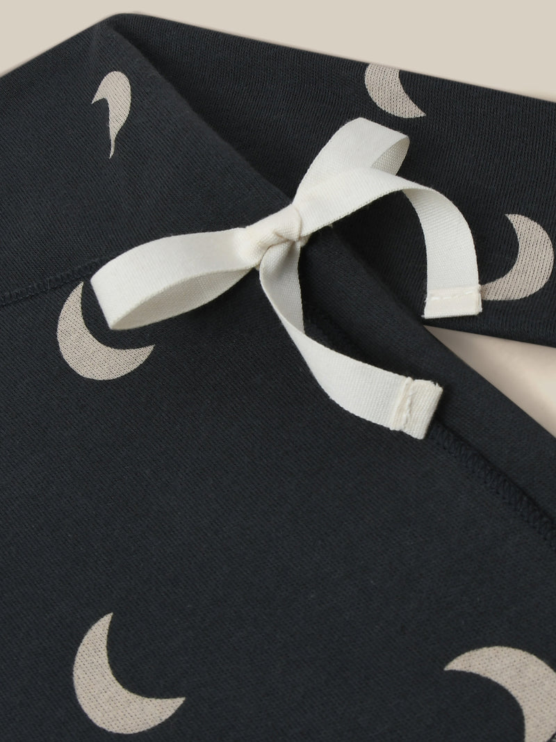 close up of kimono in black with cream moons and white ribbon bow