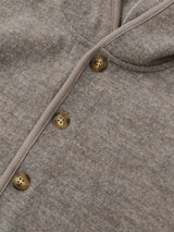 close up of button down wool jacket in cream with hood pockets & tortoise buttons