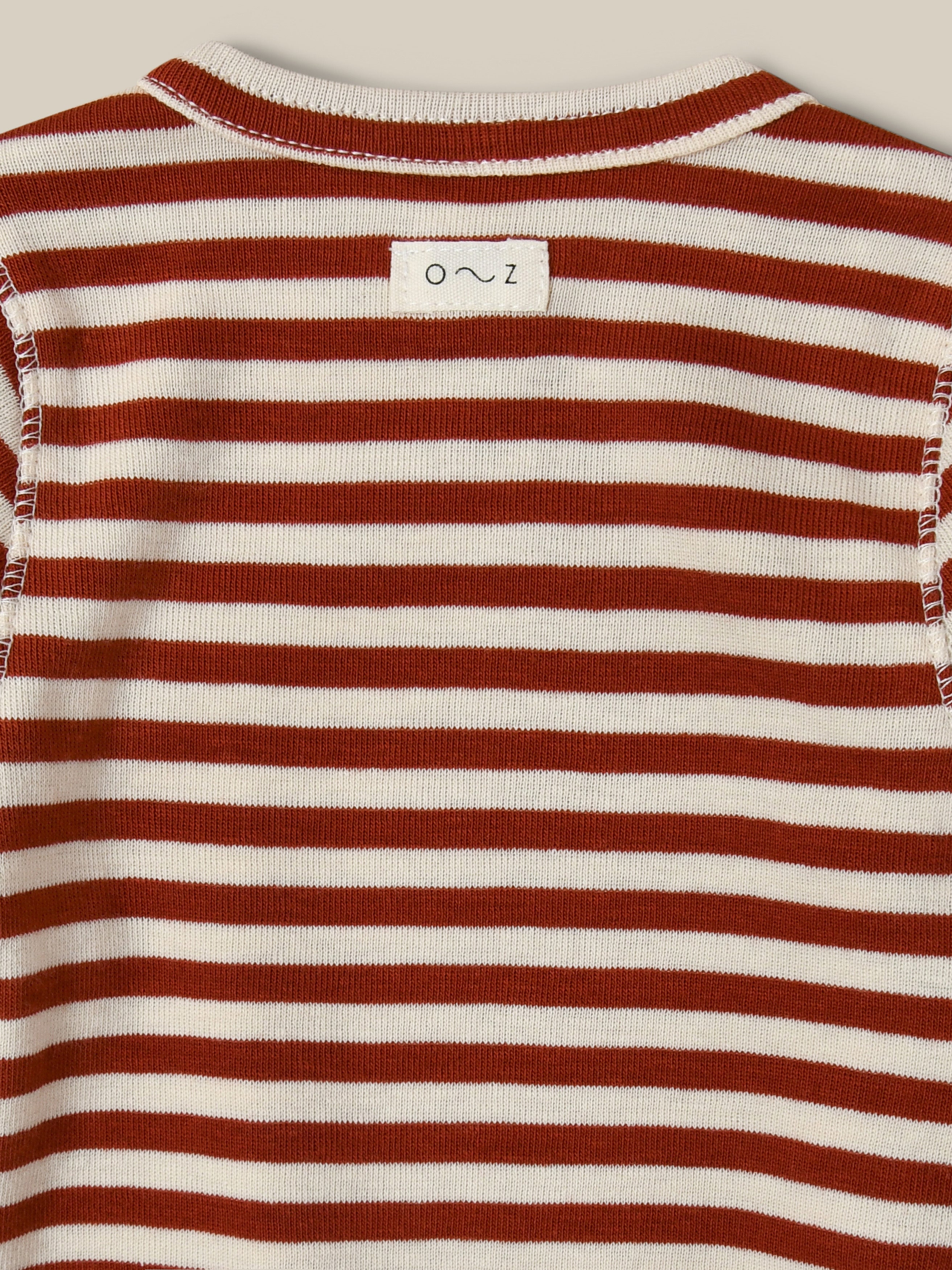 close up of ribbed cotton wrap bodysuit in red and white stripes with front and crotch poppers
