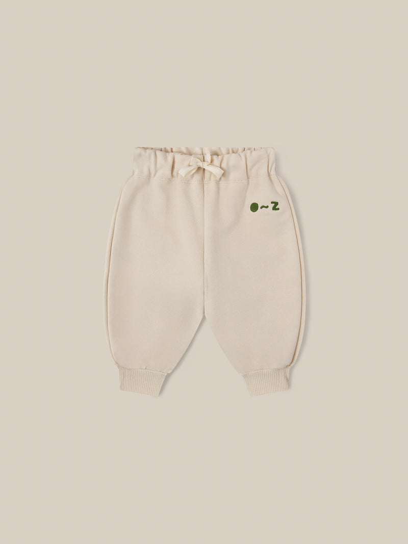 baby and toddler undyed cotton drawstring sweatpants in cream with O ~ Z embroidered in green