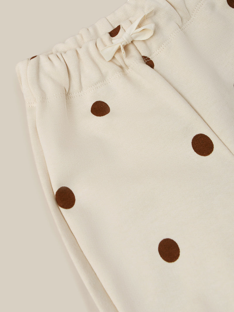 close up of undyed cotton drawstring sweatpants in cream with brown dots