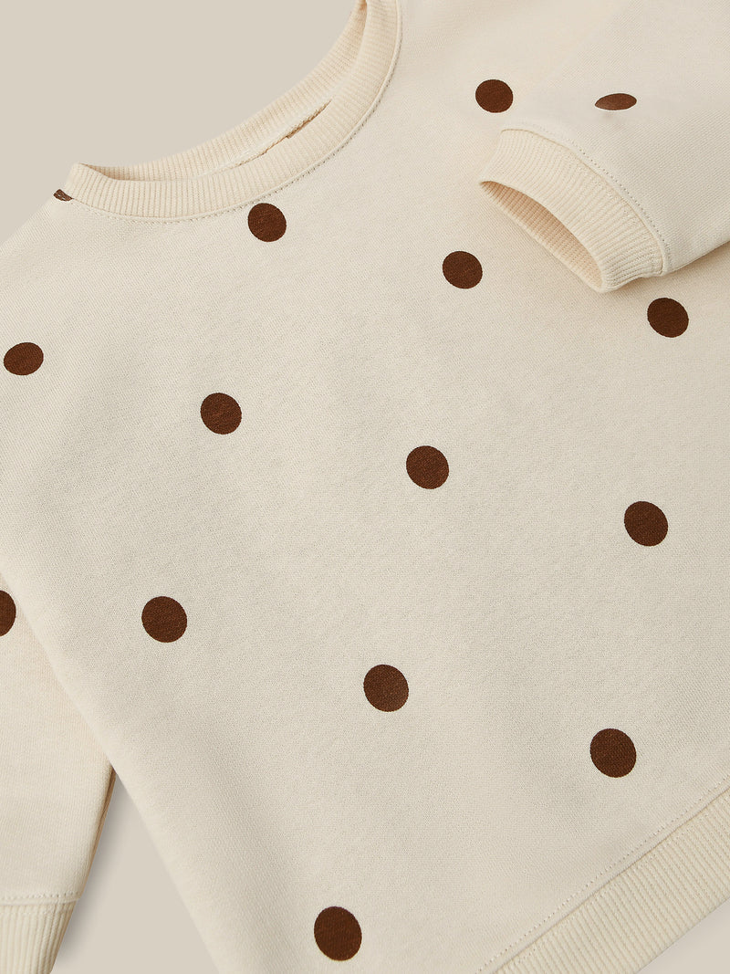 close up of undyed cotton sweatshirt in cream with brown dots