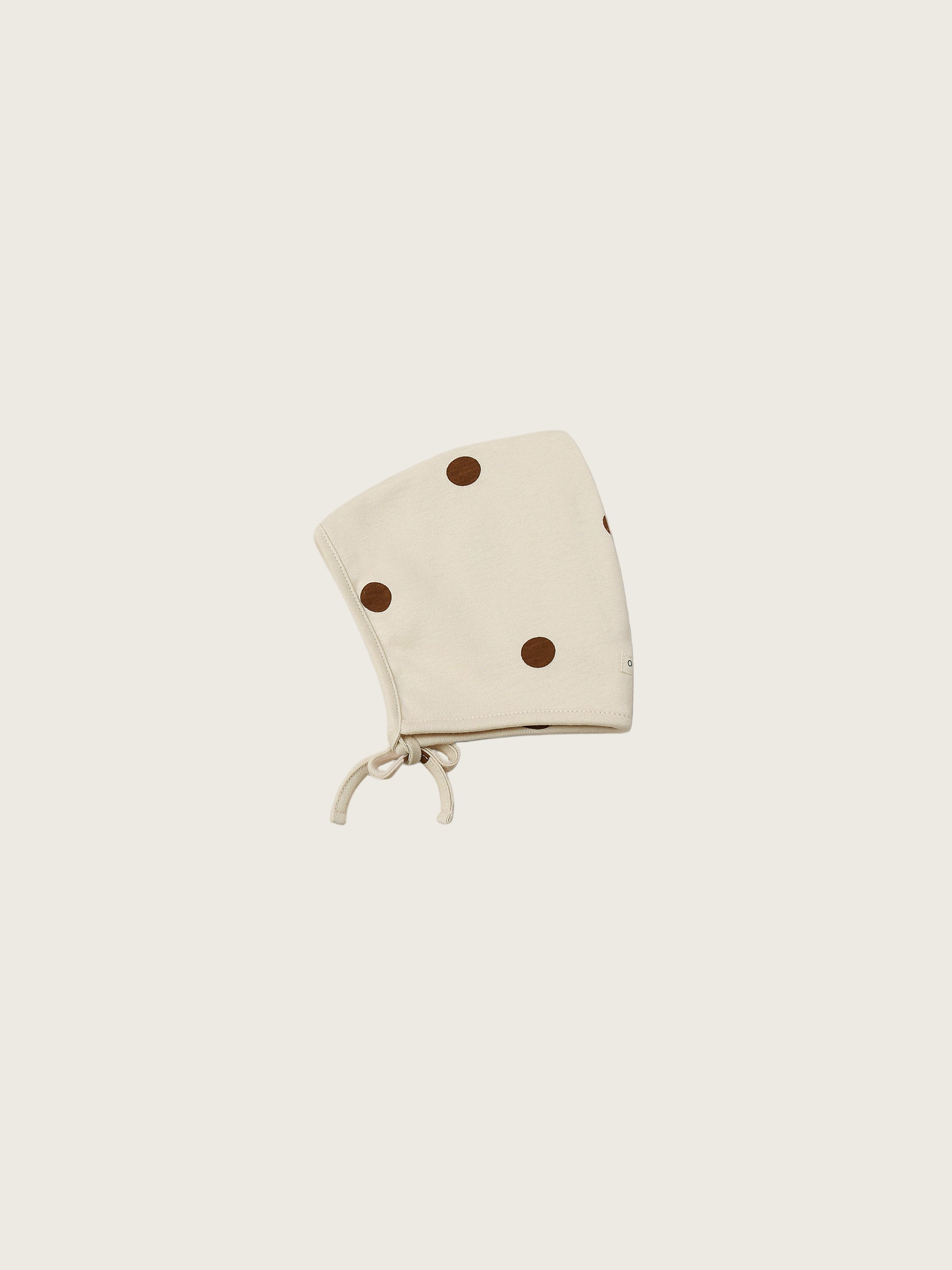 baby and toddler undyed cotton pixie bonnet in cream with brown dots and chin tie
